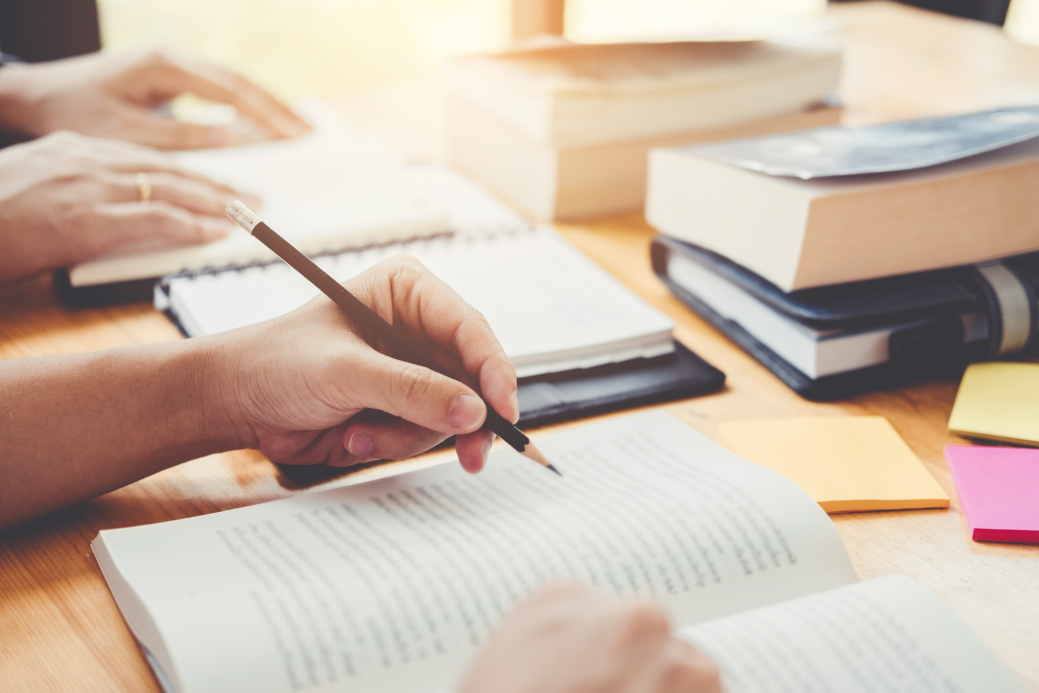 high school or college students studying and reading together in