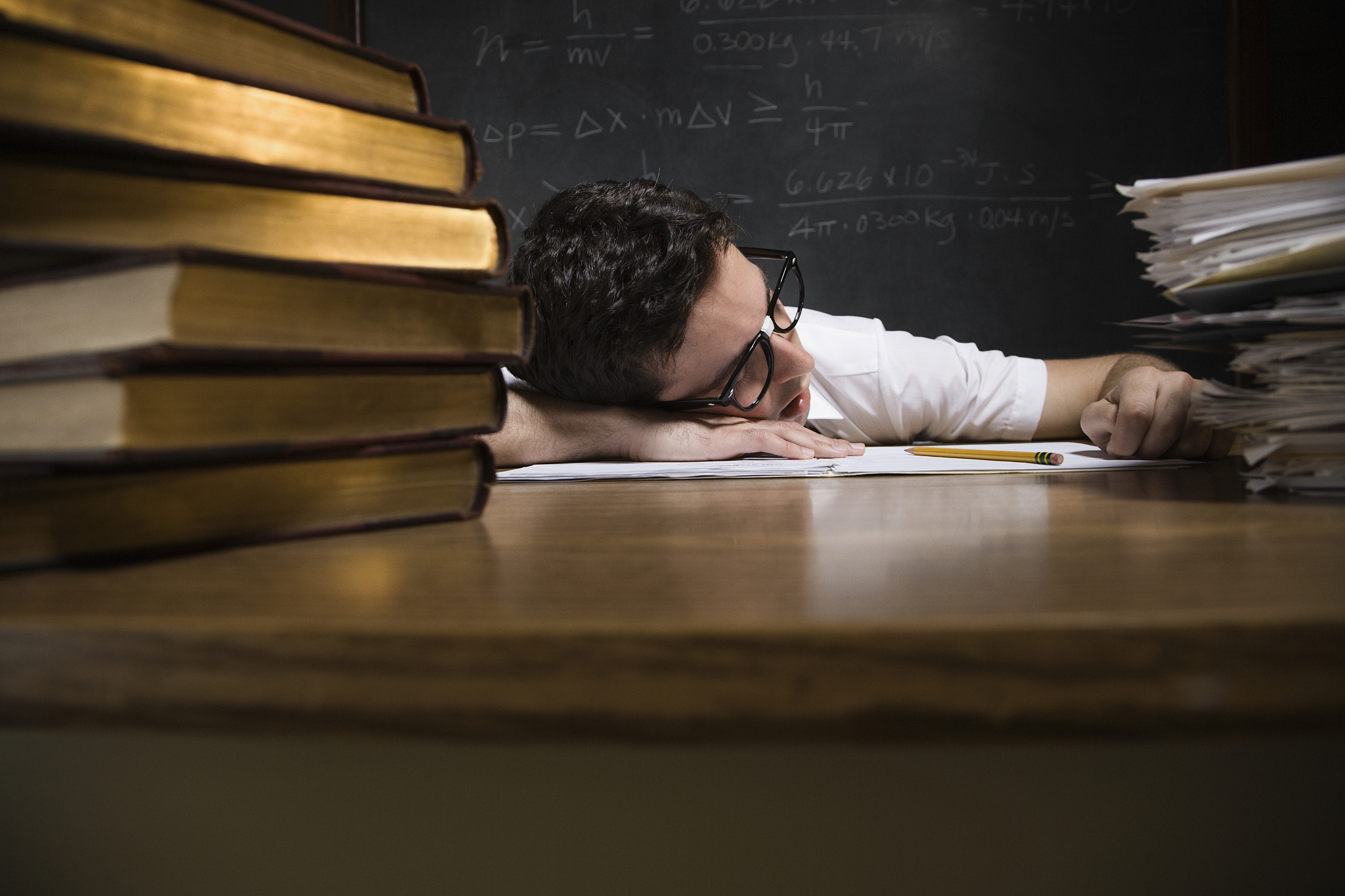 nerdy man sleeping on school desk