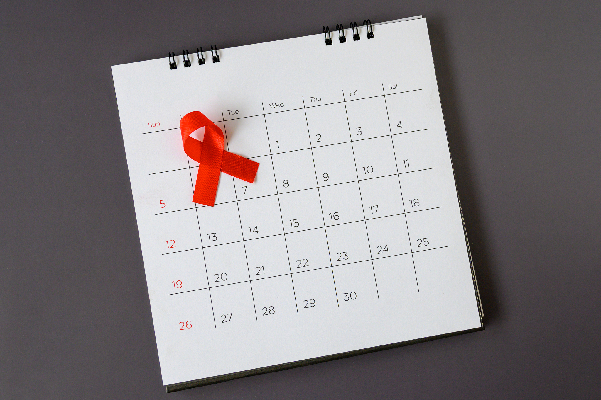 world aids day concept, red ribbon the date 1 december
