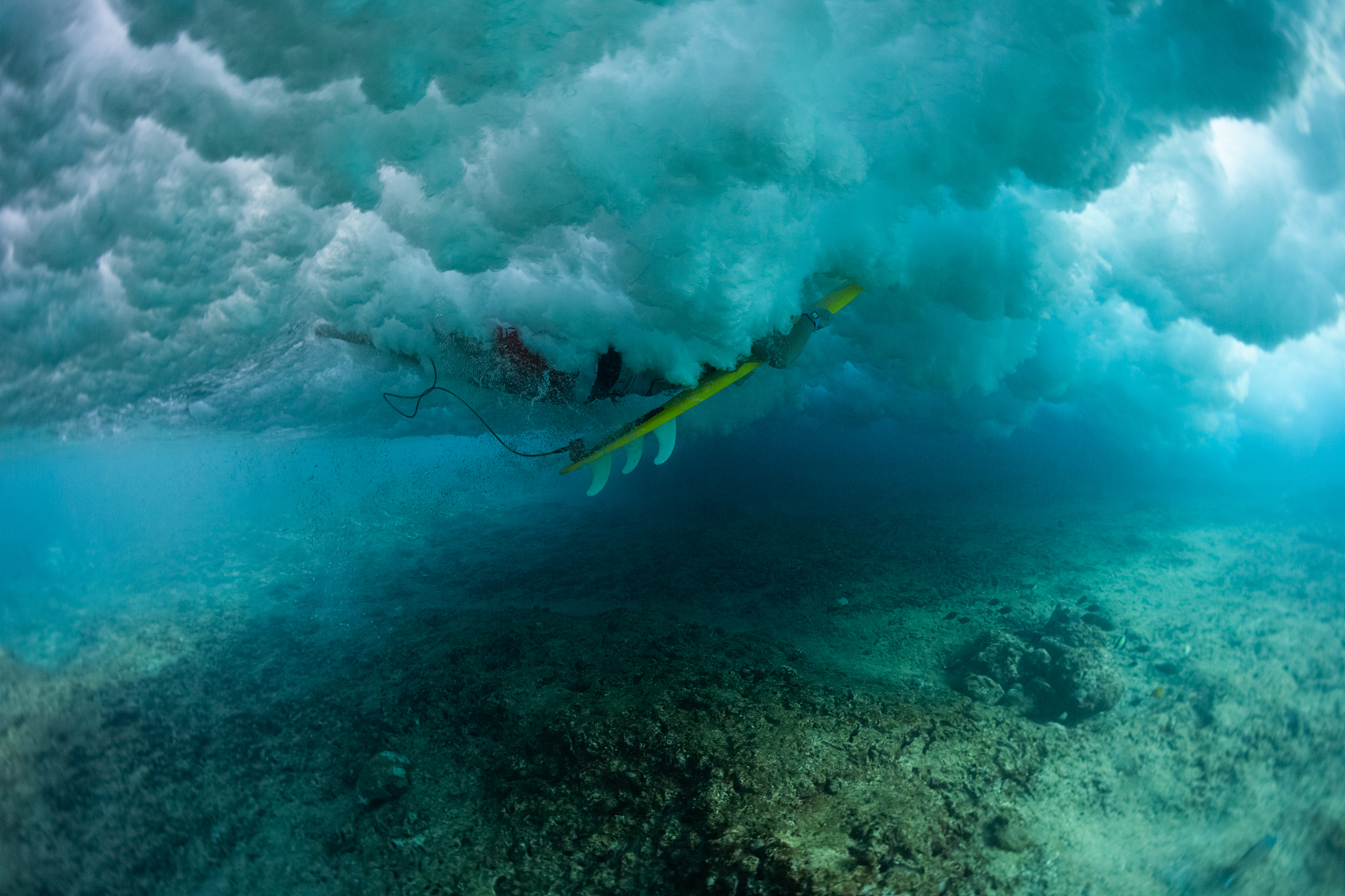 underwater view of the surfer passing the ocean wave