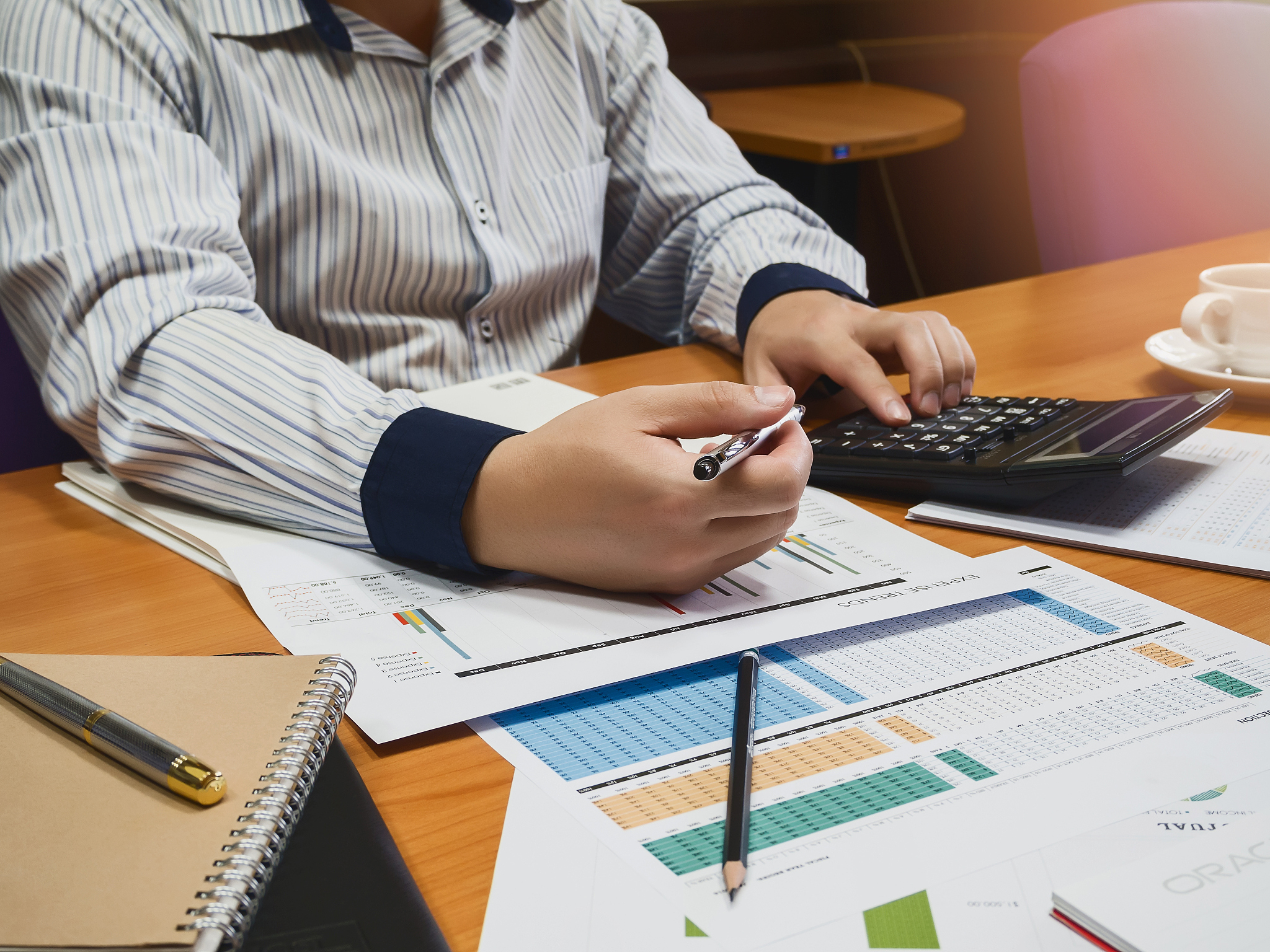 businessman holding a pen for working on his plan project