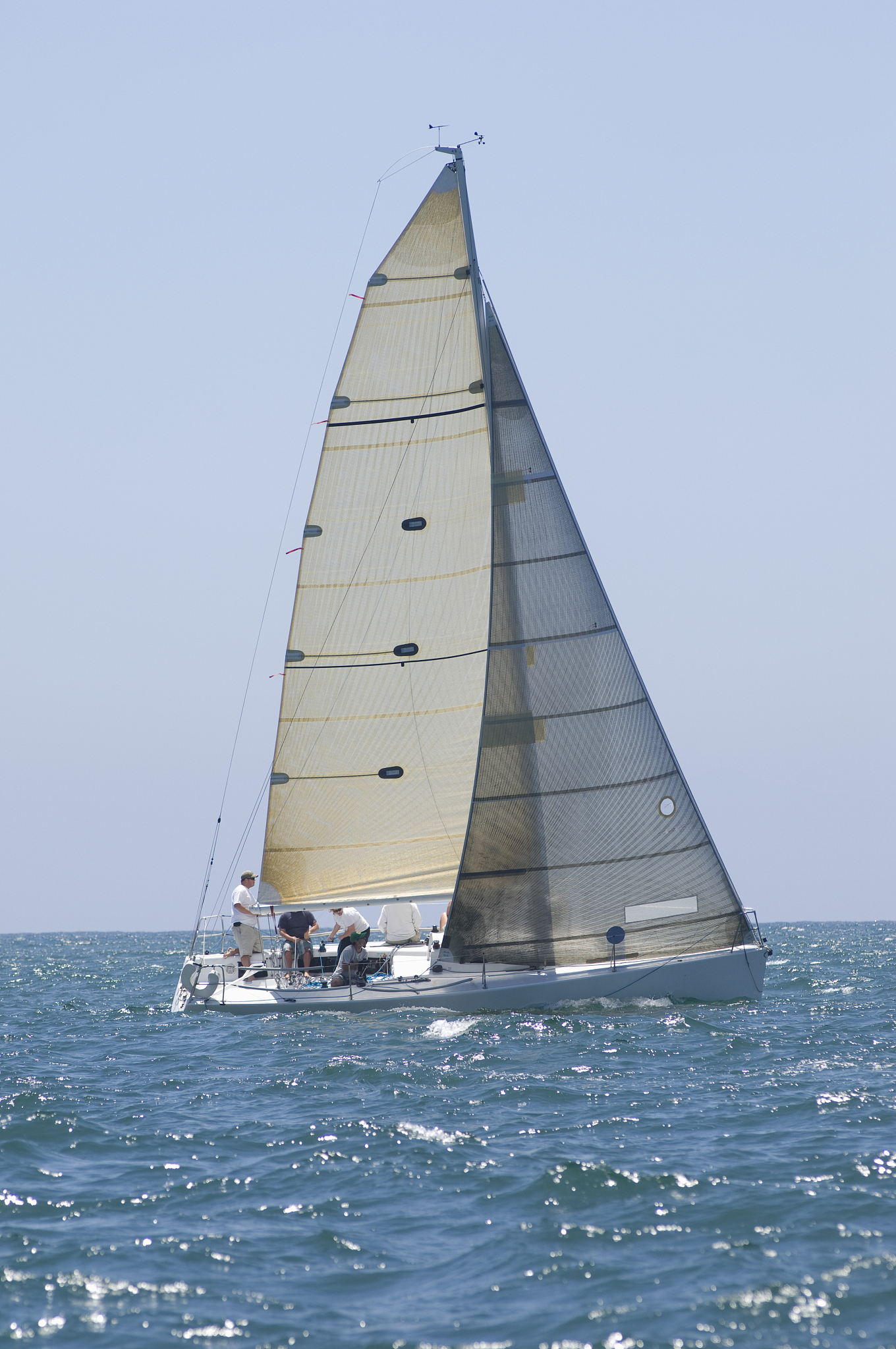 sailboat racing in the blue ocean against sky