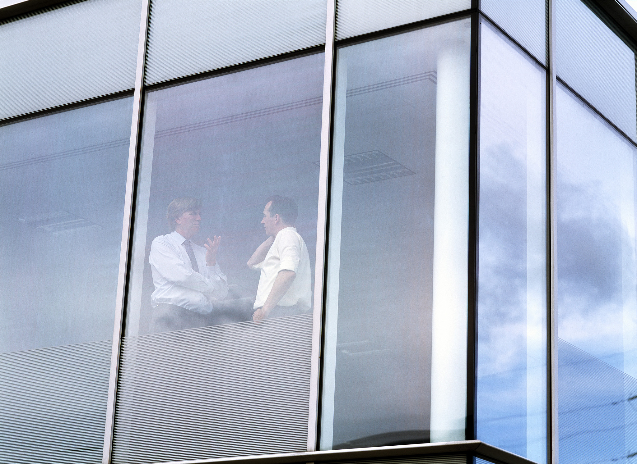 businessmen having discussion in office, low angle view