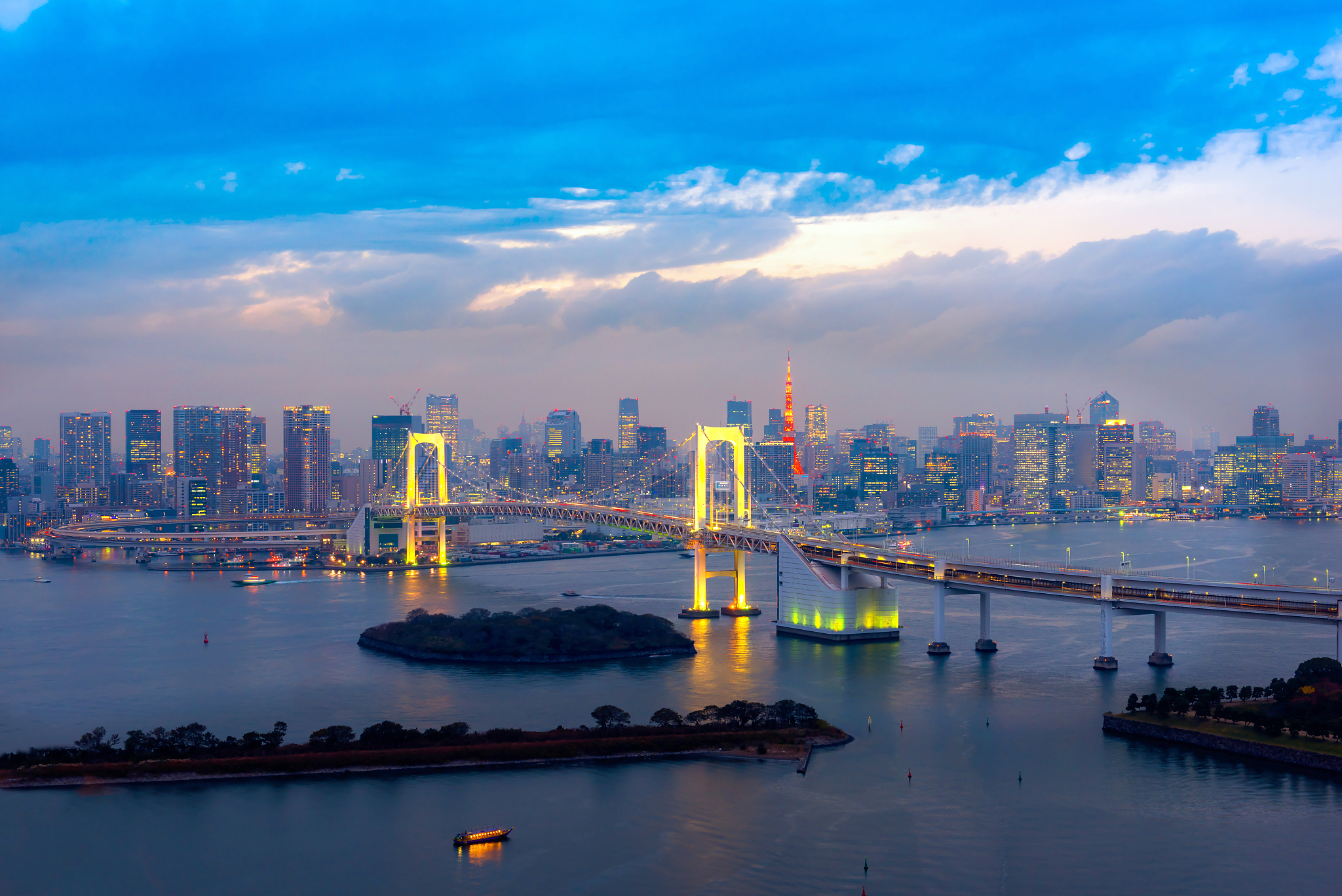 city at waterfront against cloudy sky