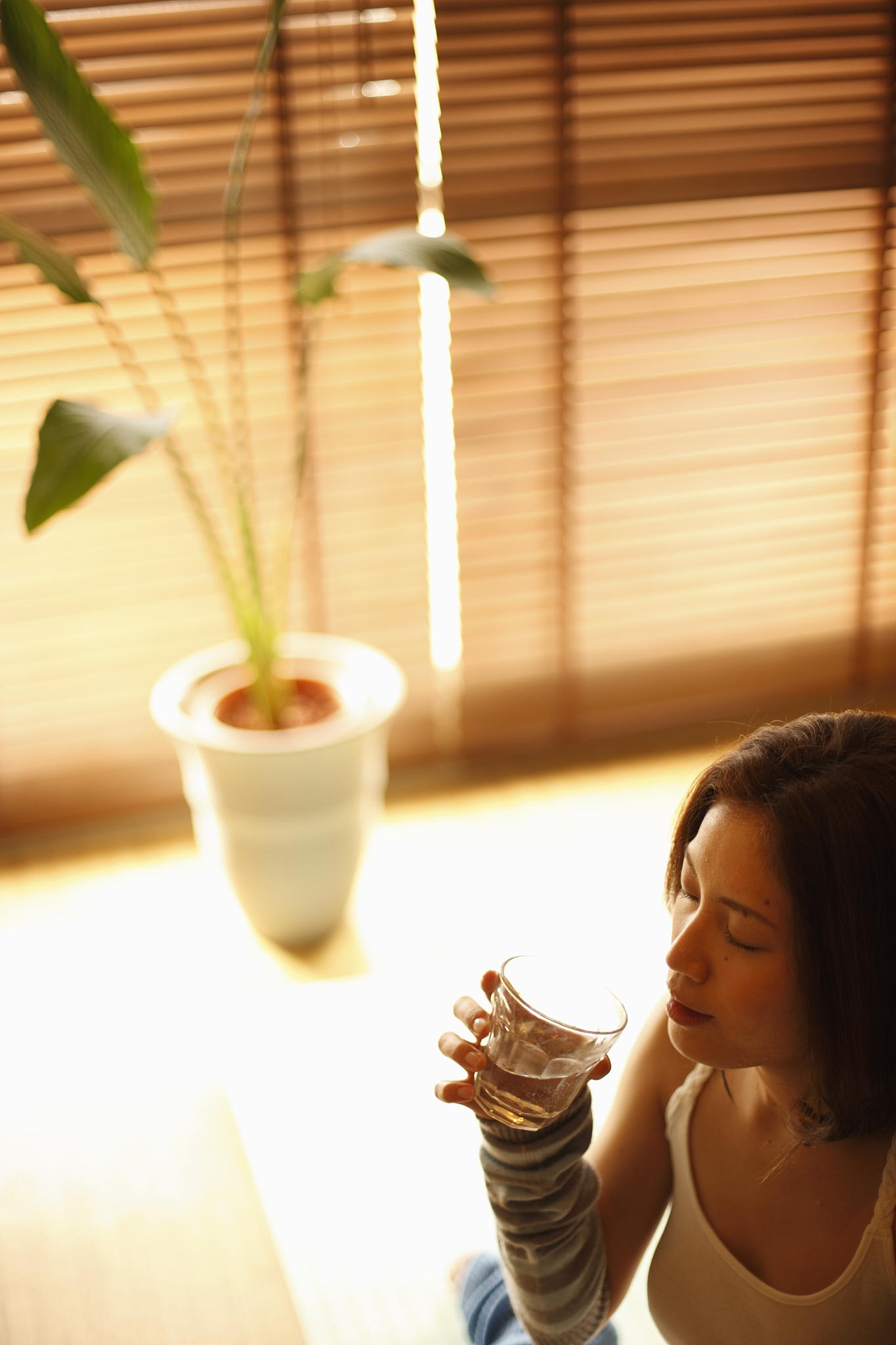 a woman drinking a glass of water