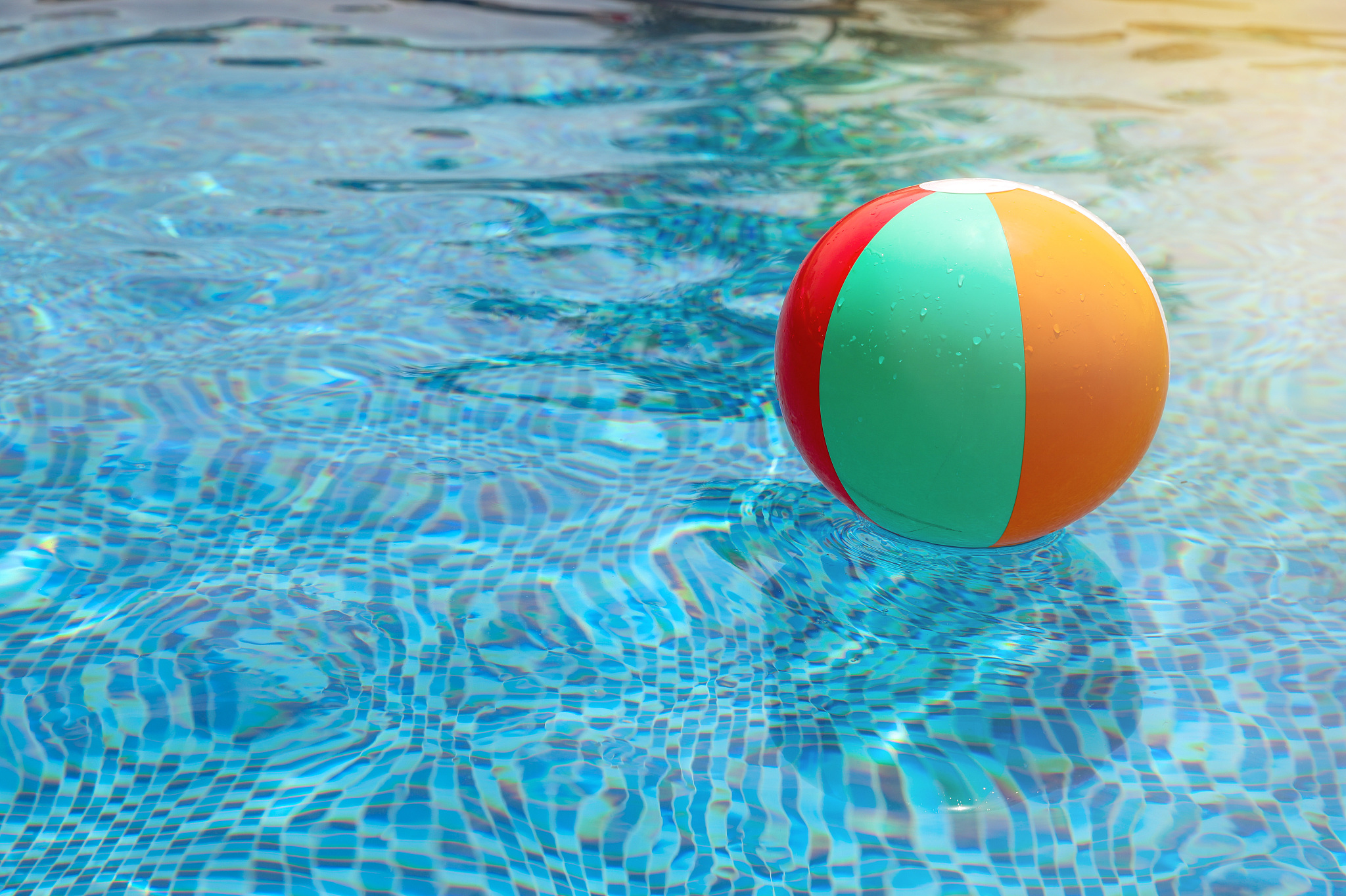 beach ball in pool. colorful inflatable ball floating in swimmin