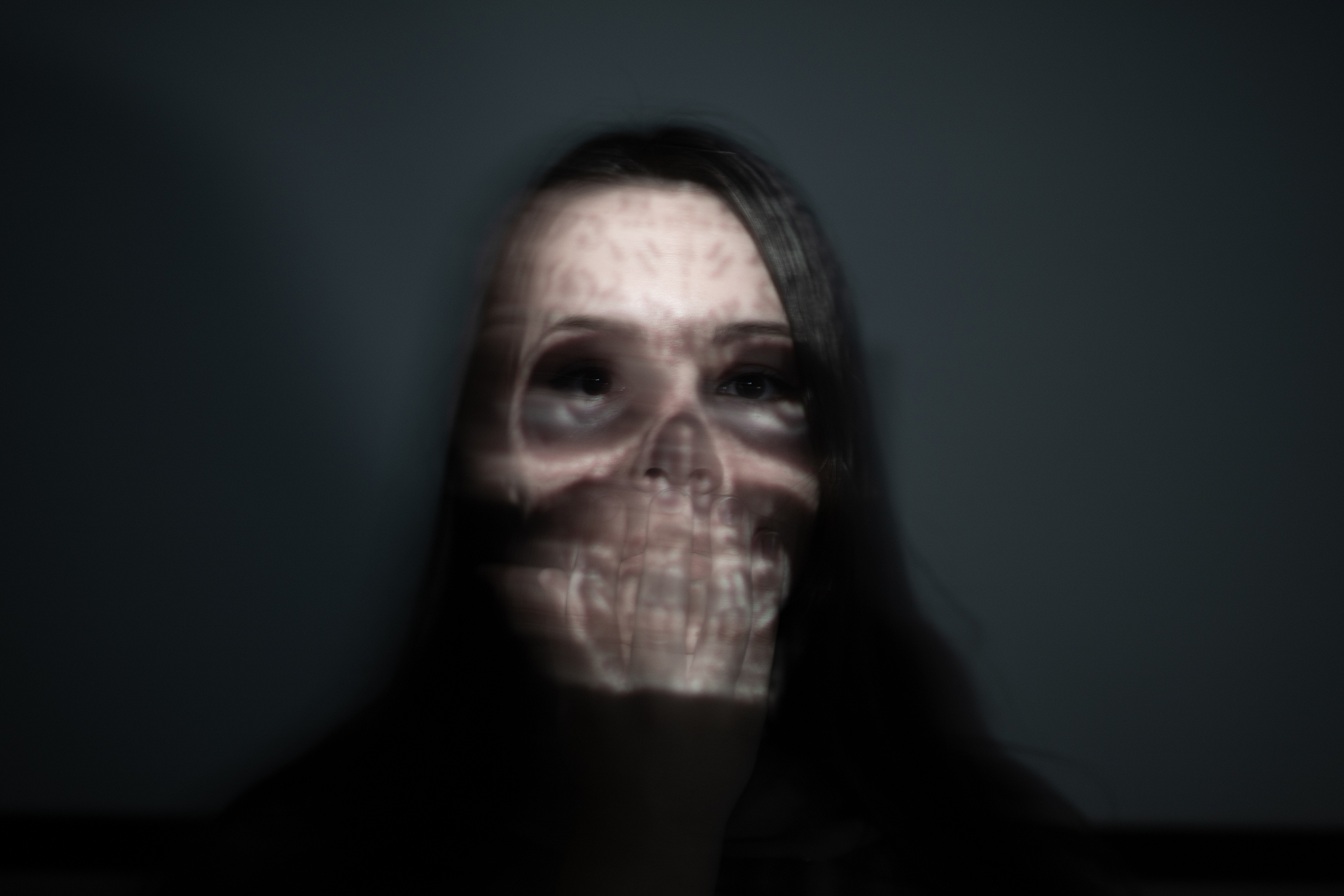 digital composite image of spooky woman against black background