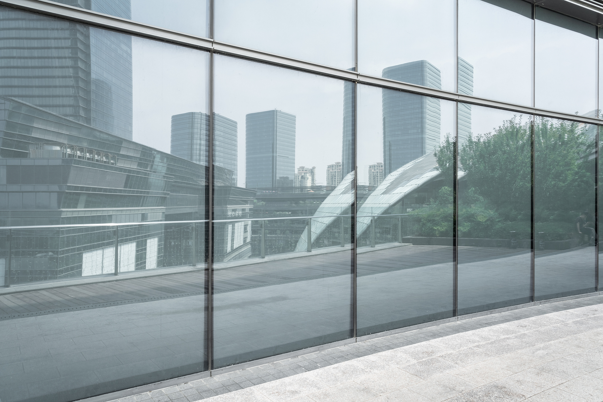 reflection of blue curtain wall glass in modern architecture