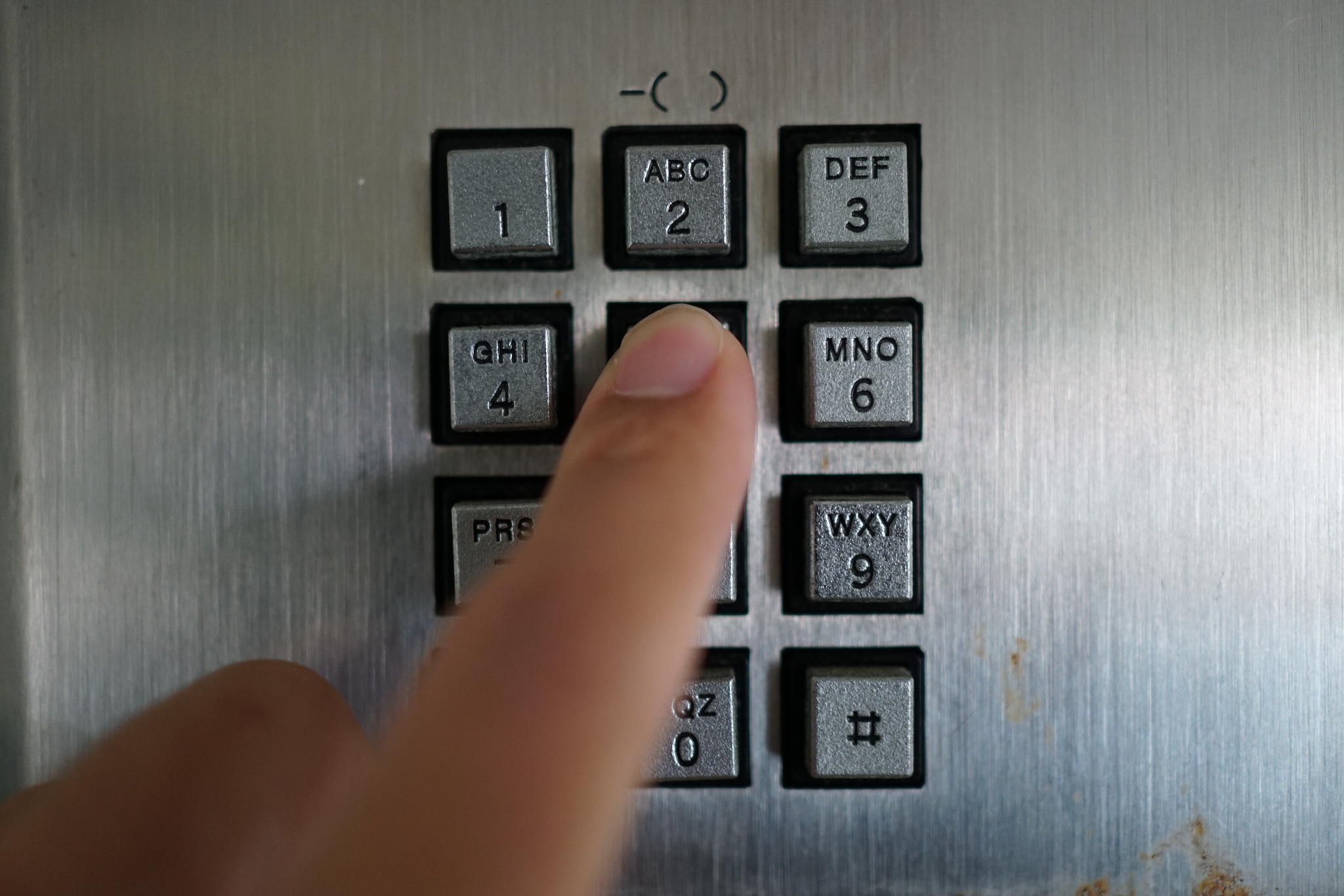 man's hand with public phone.