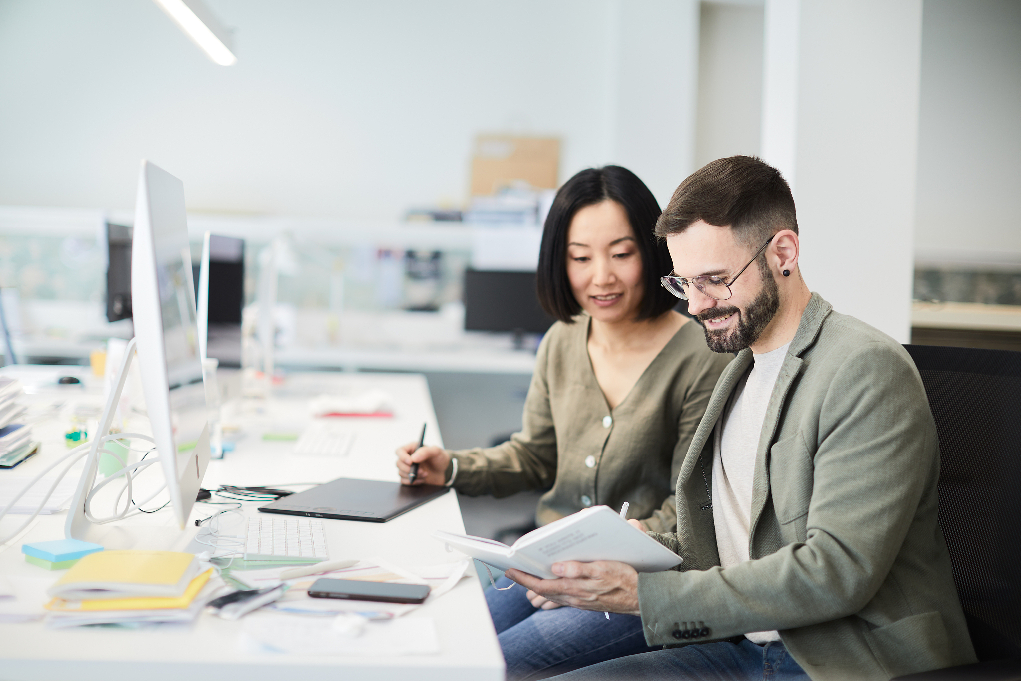 business colleagues share ideas on an open space office.