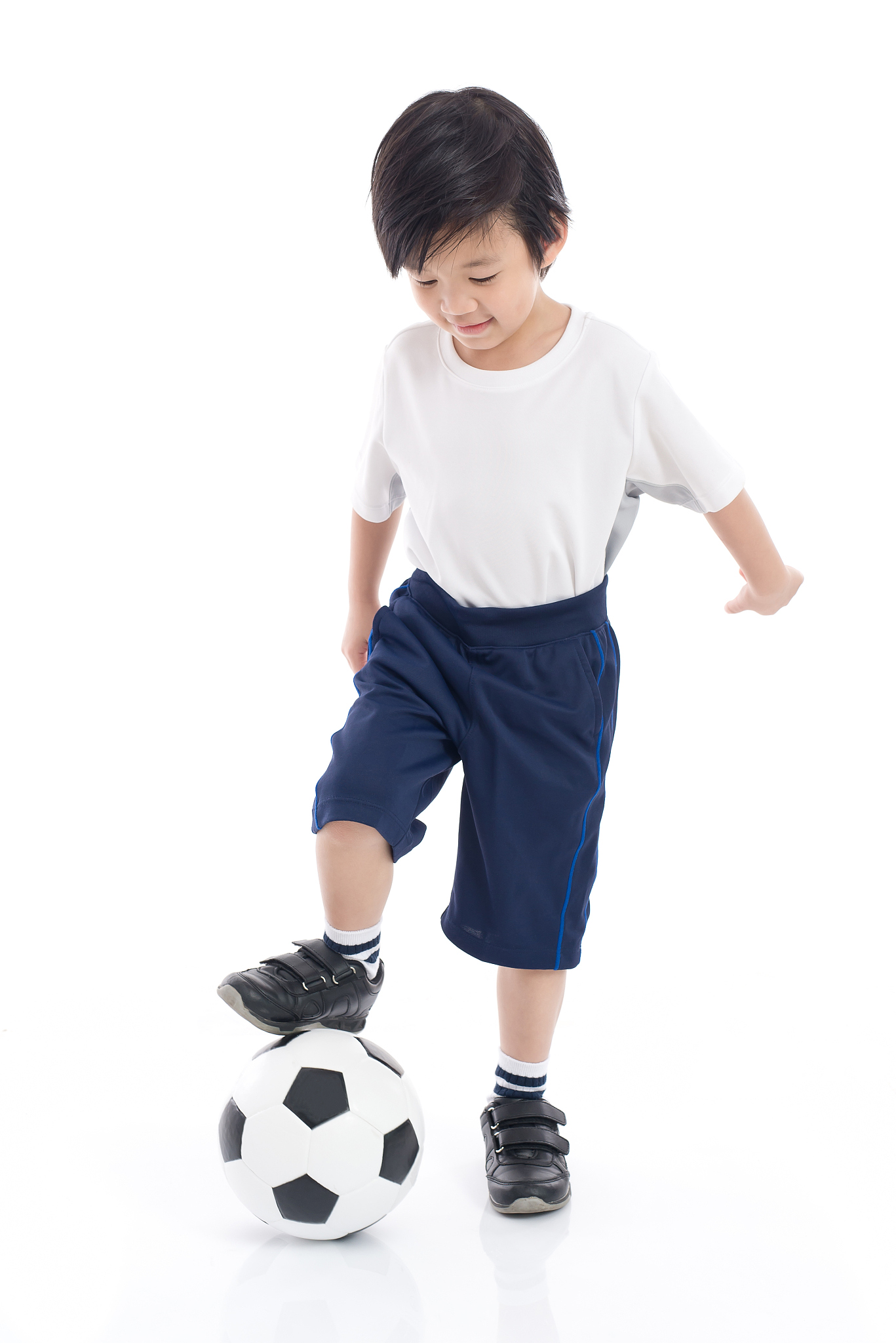 asian child with football on white background