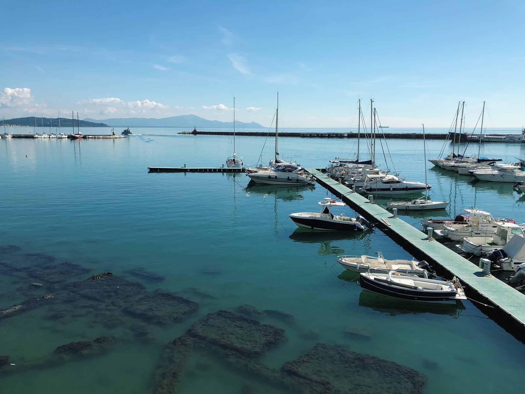 sailboats moored at harbor against sky