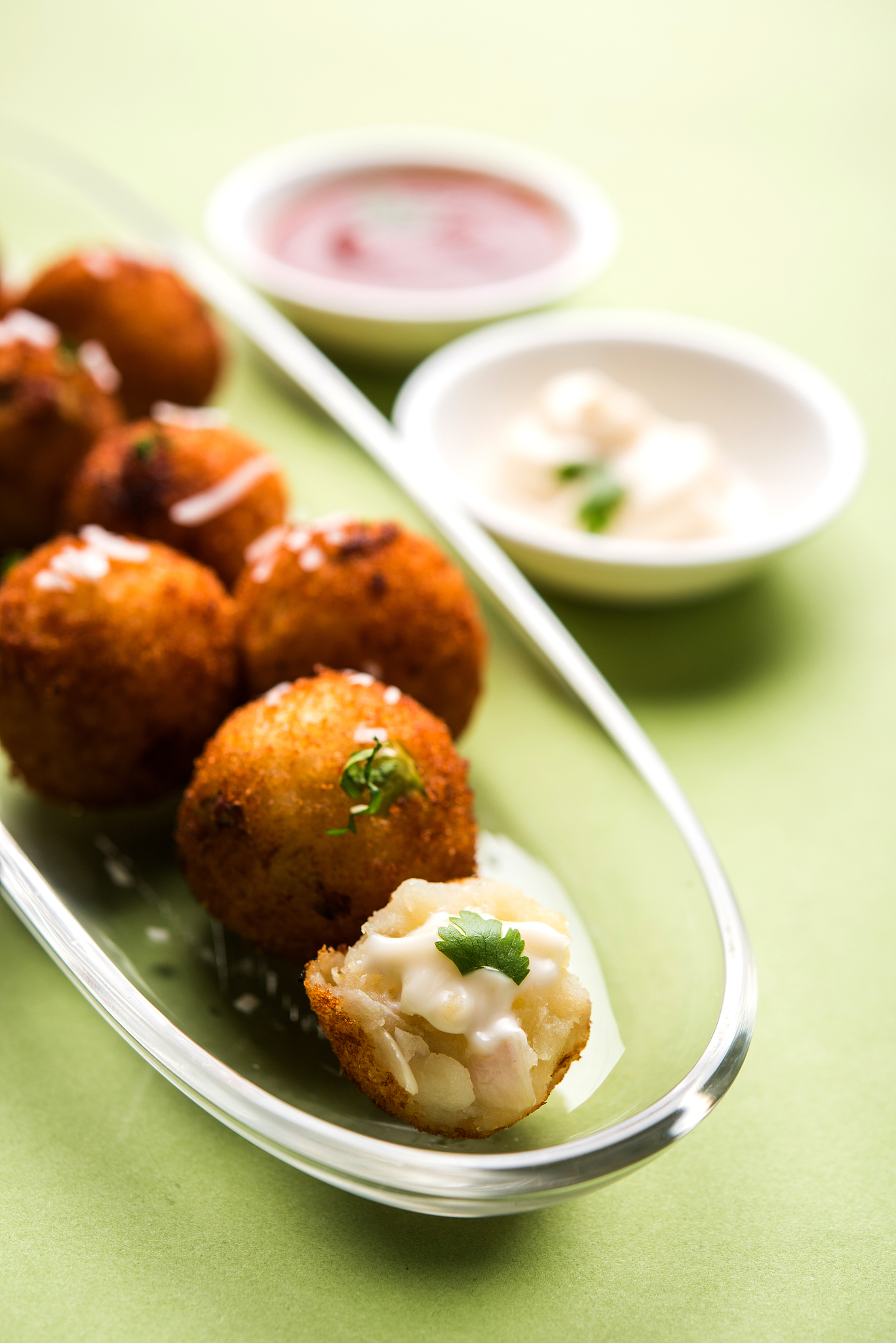 fried potato cheese balls or croquettes with tomato ketchup. sel