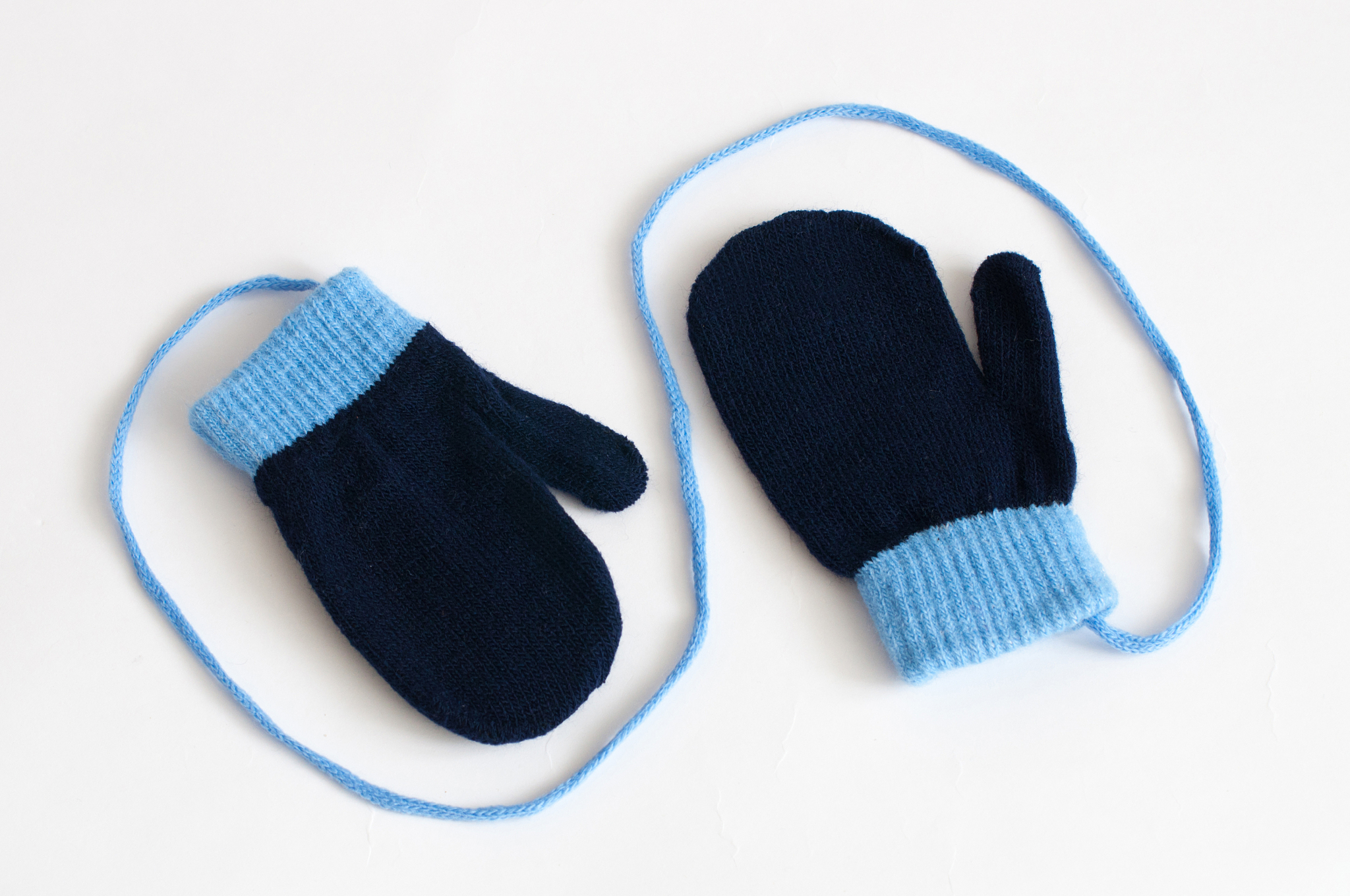 blue knitted mittens on a white background