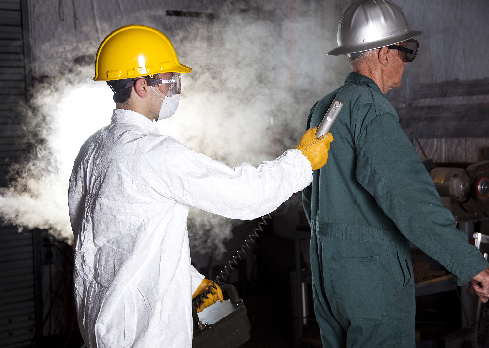 safety inspector with geiger counter testing worker