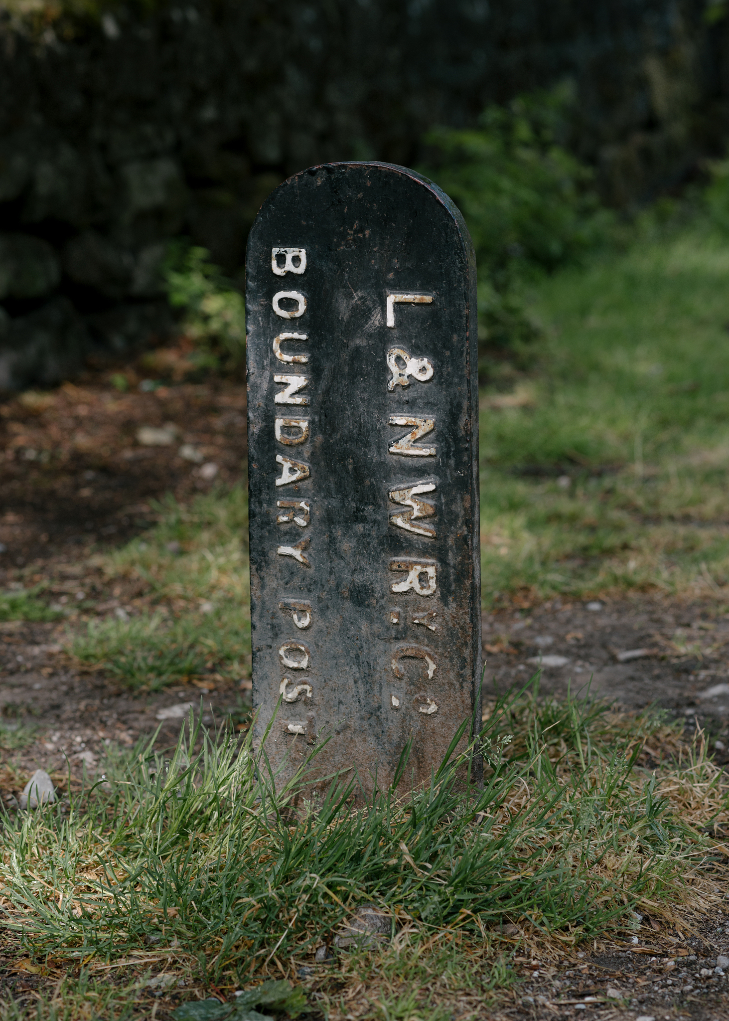 old metal railway boundary sign with white lettering