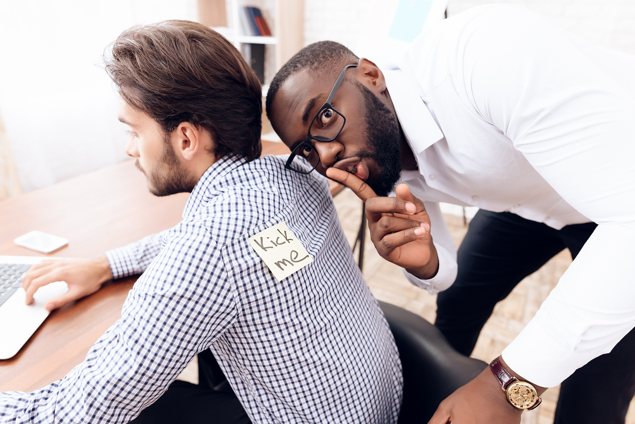 the men stuck a sticker on the back of another man.