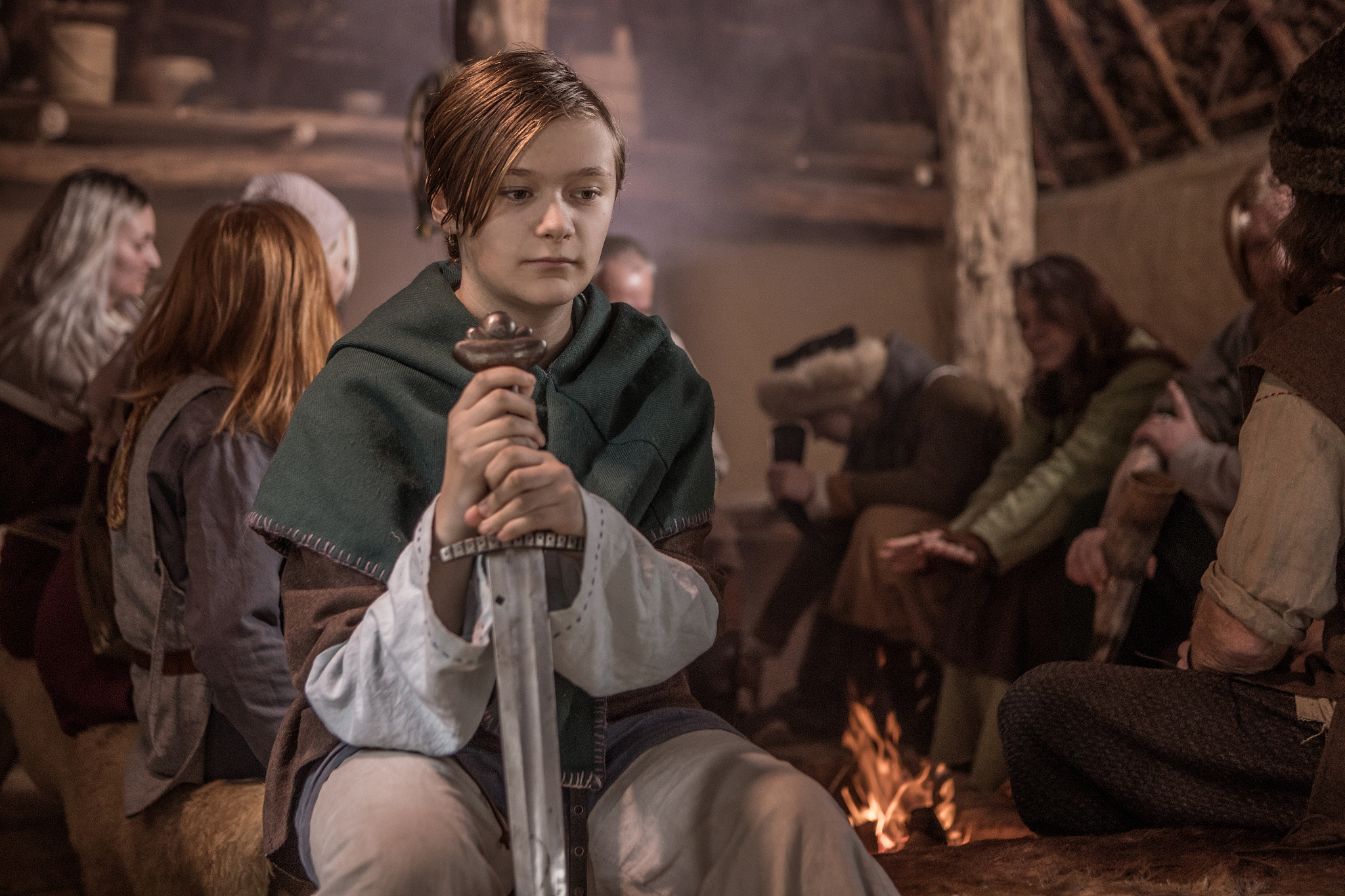 an individual viking woman in a viking settlement hall