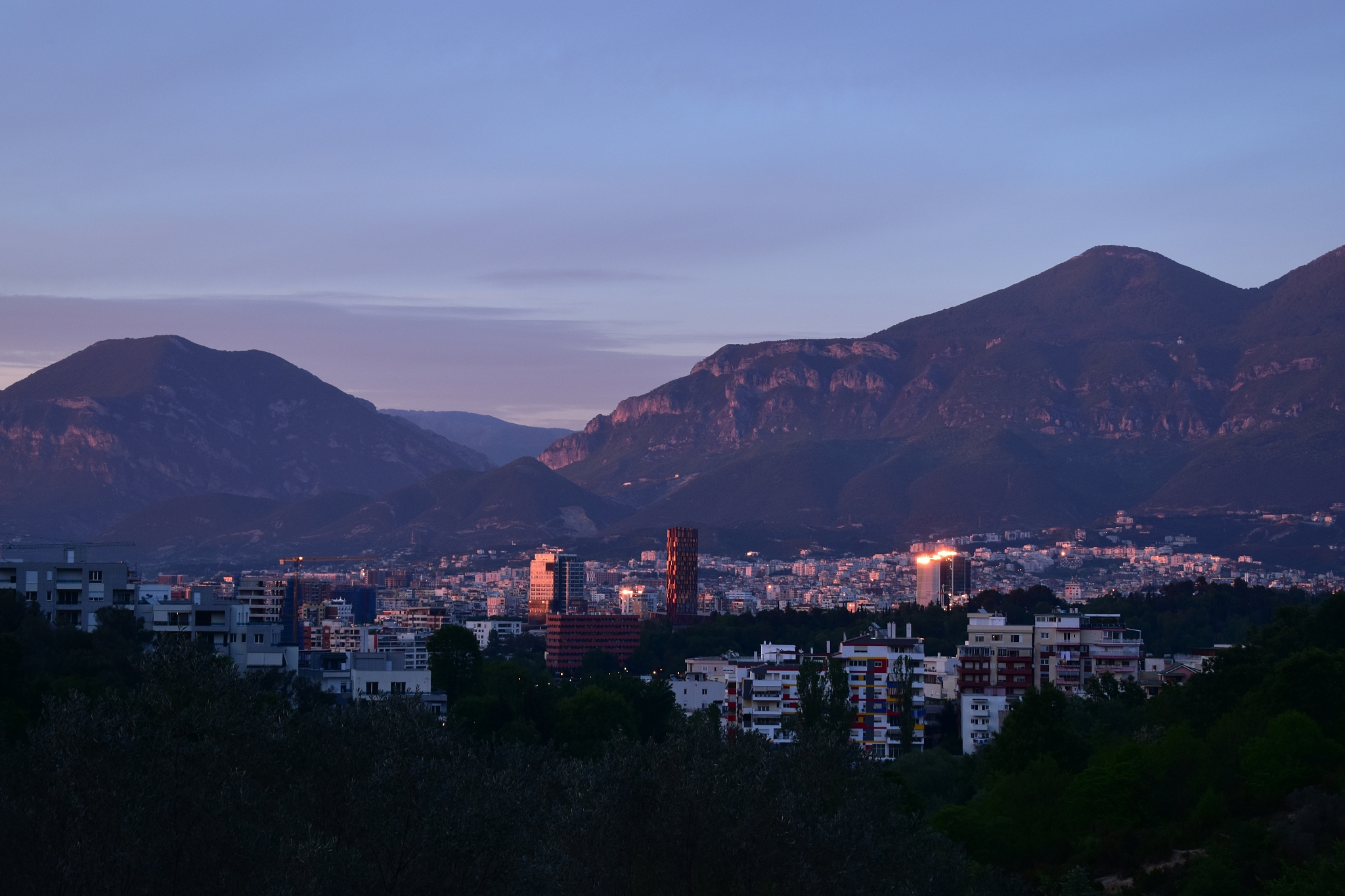high angle view of townscape by mountain against sky