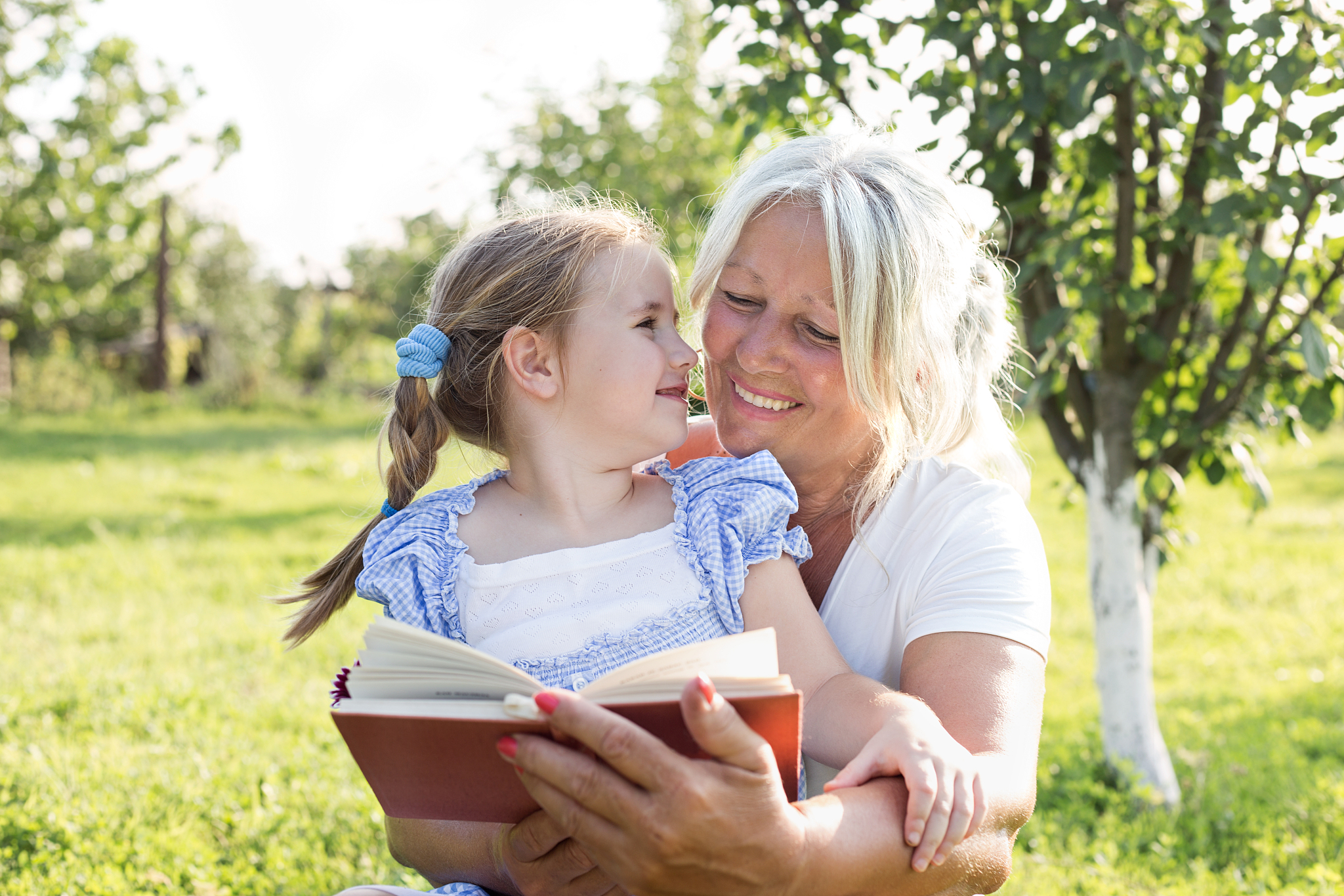 grandmother and granddaughter reading book