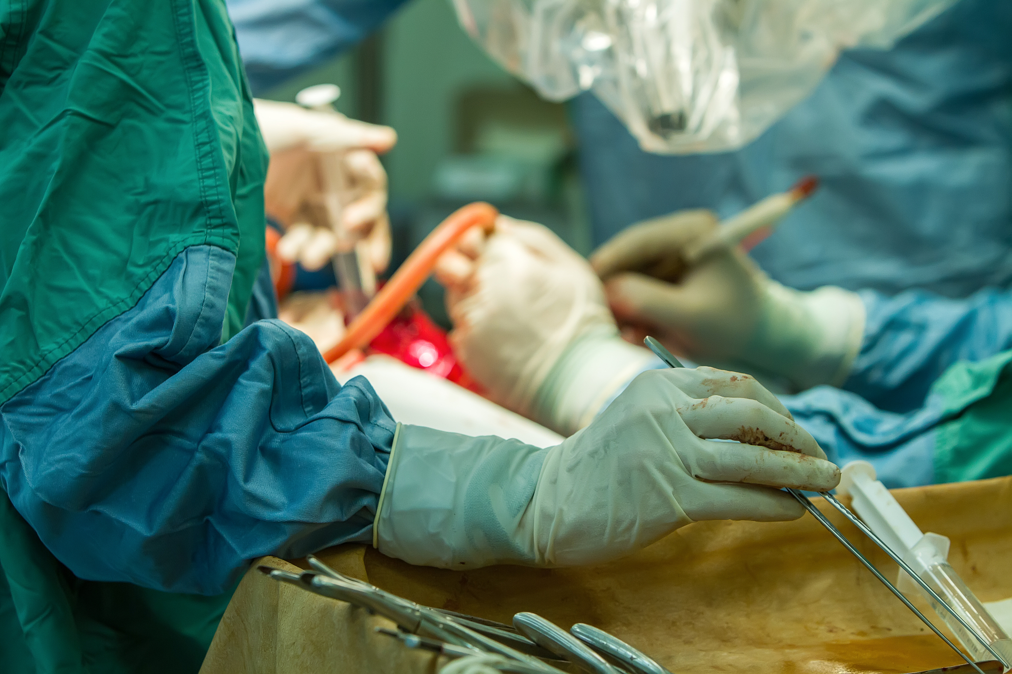 hands of surgeons with tools.