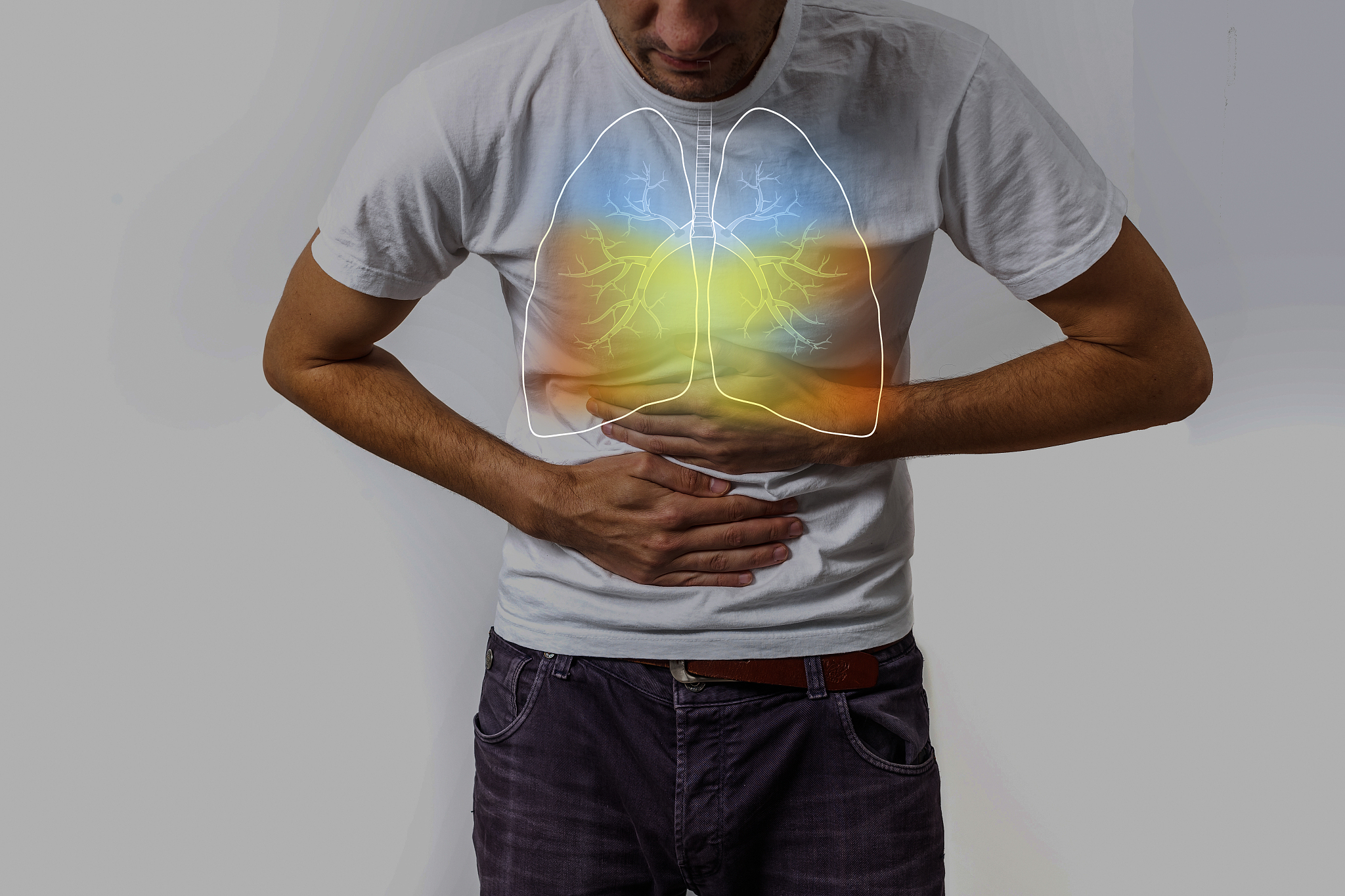 human lungs, man holding his hand in the area of their lungs.