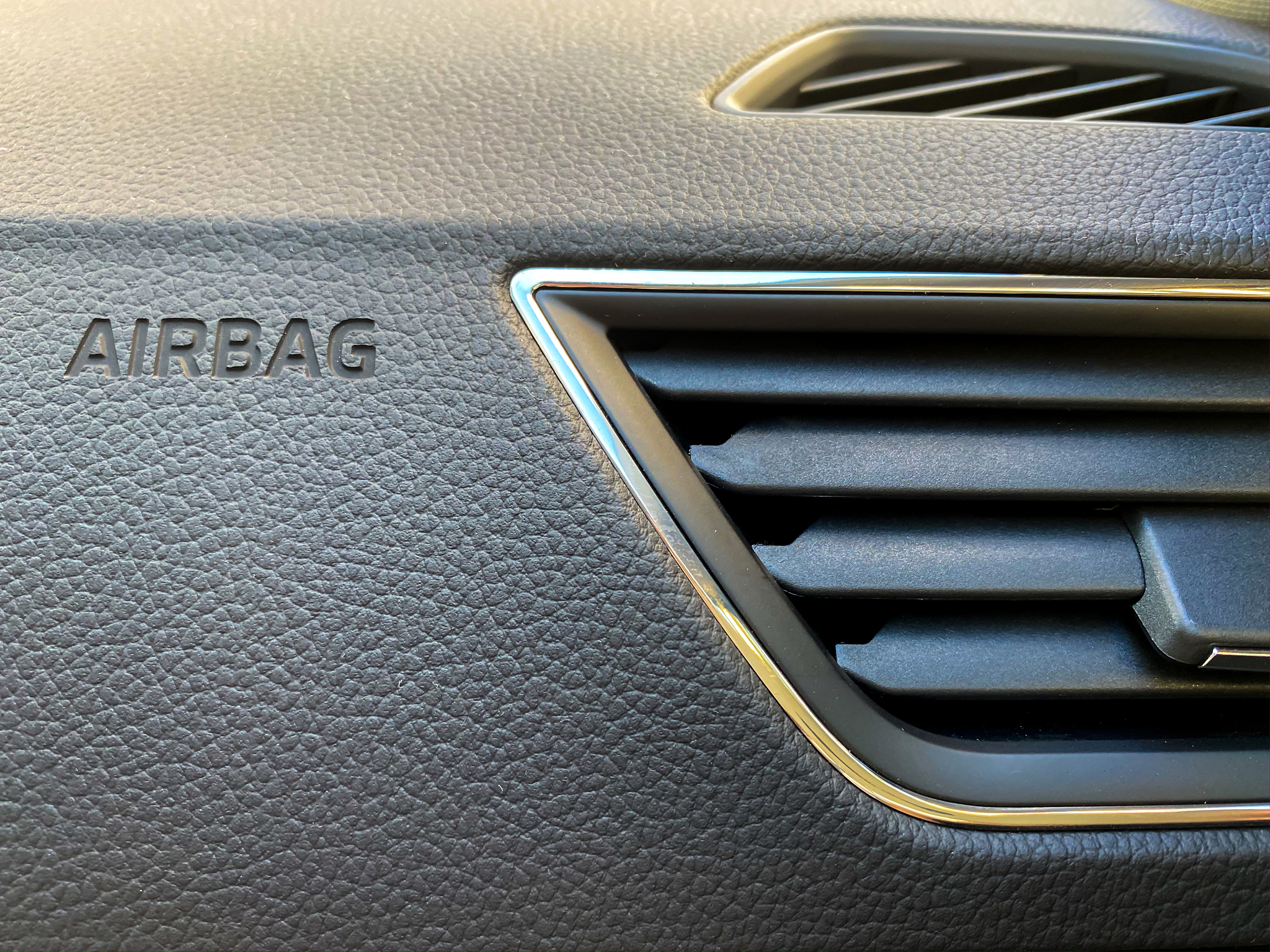 macro of an airbag sign on a dashboard.