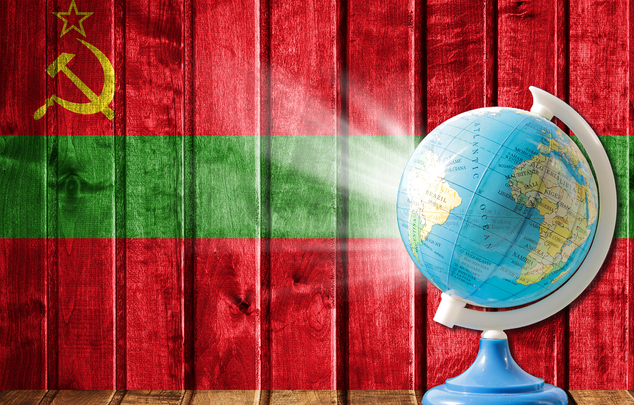 globe with a world map on a wooden background with the image of 