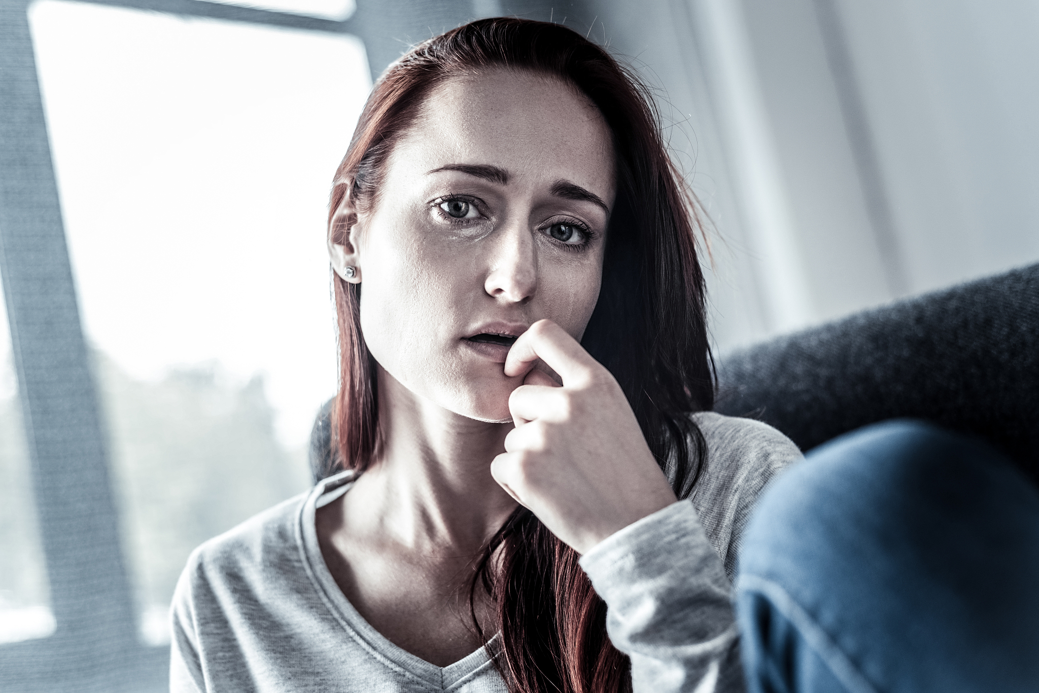 depressed upset woman feeling bed herself and looking straight