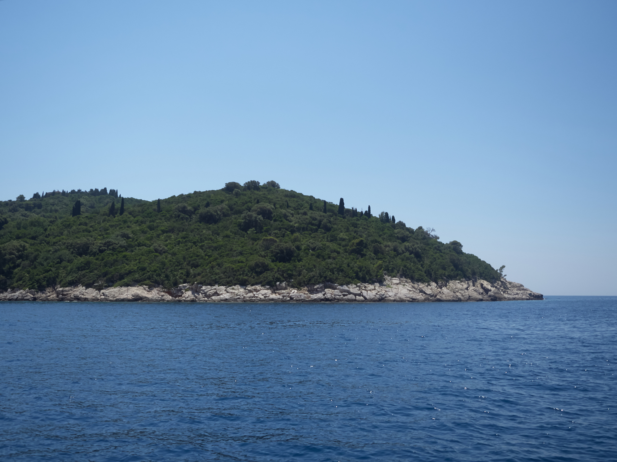 view of lokrum island during a boat trip in a sunny summer day. 