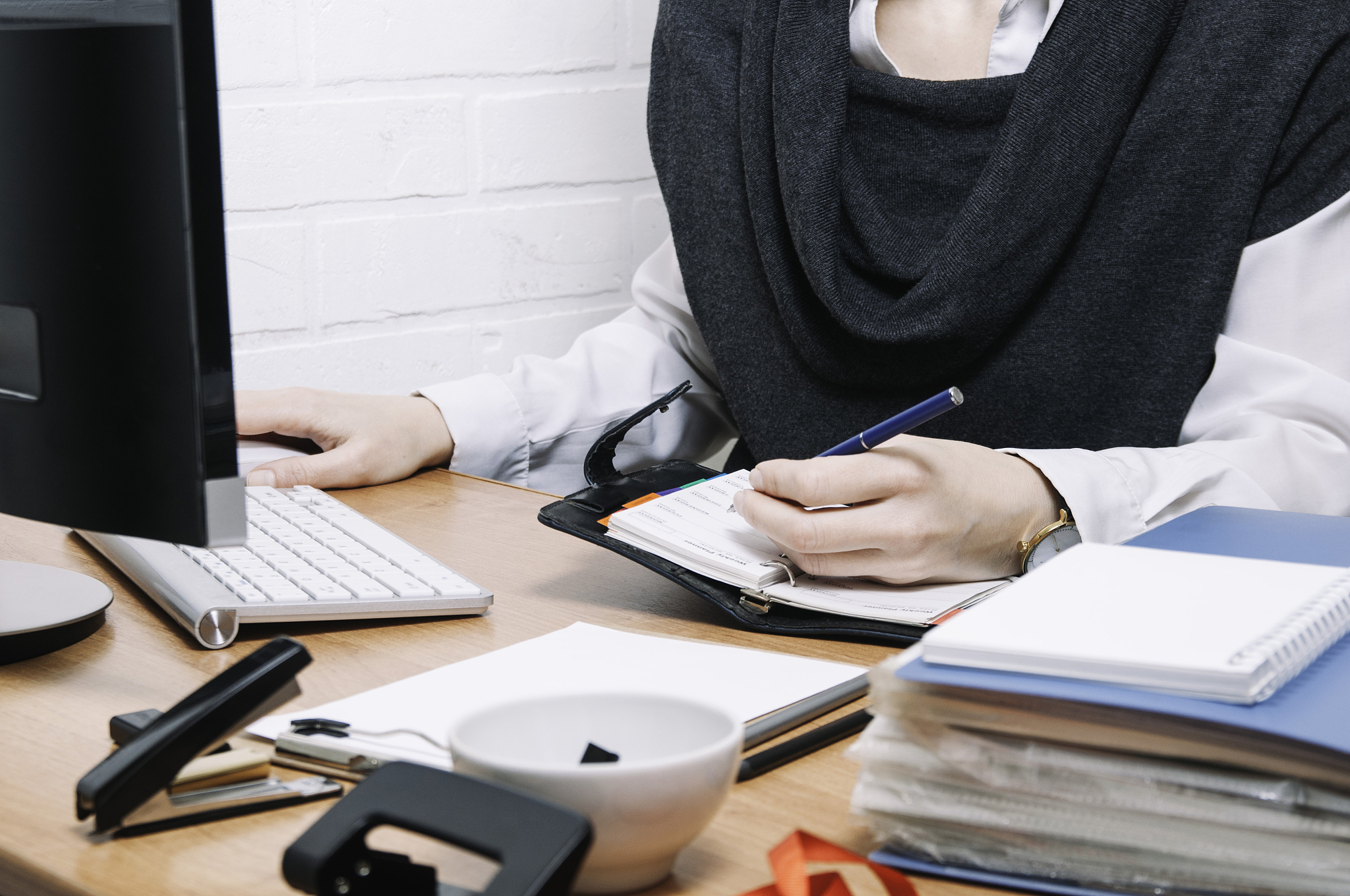 business woman writes in a notebook. the concept of office work