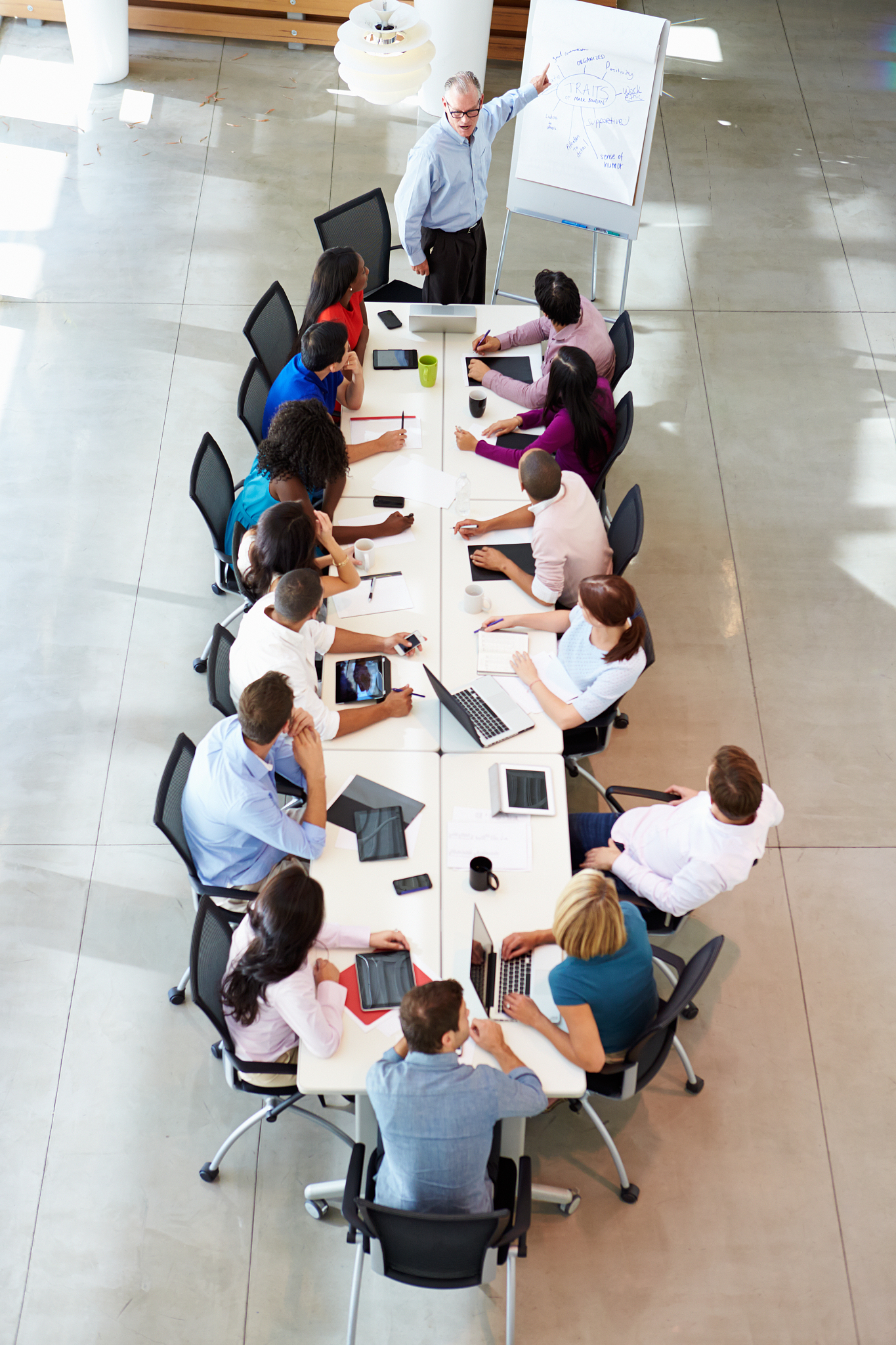 business people having a meeting at a large boardroom table