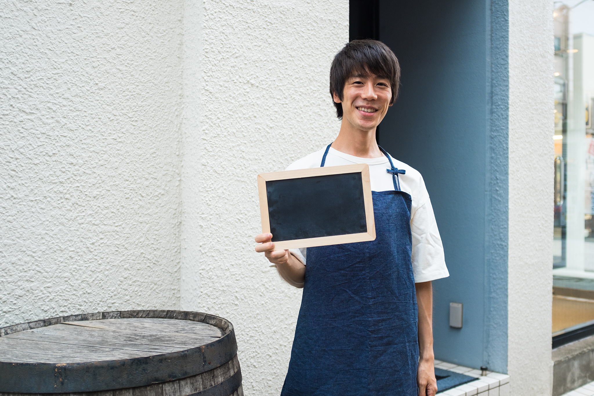 man holding black board