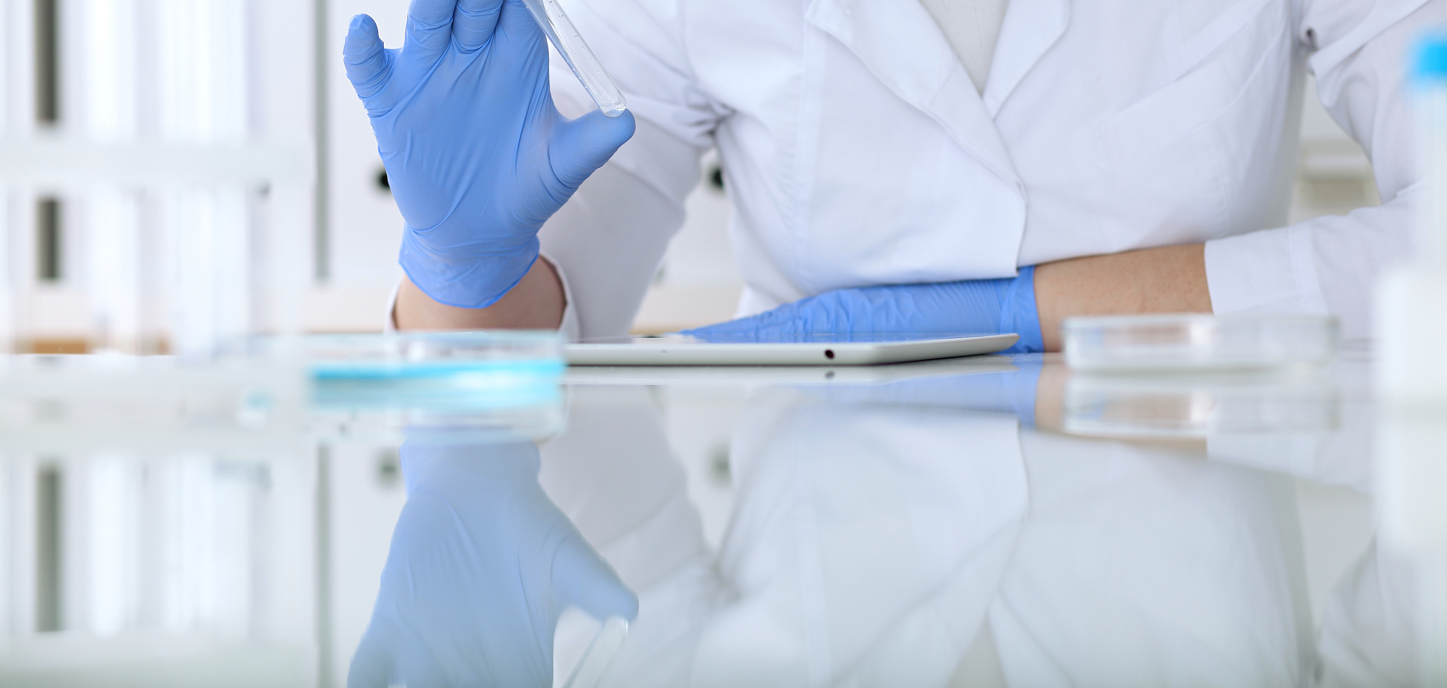 close up of scientific research hands with clear solution in lab