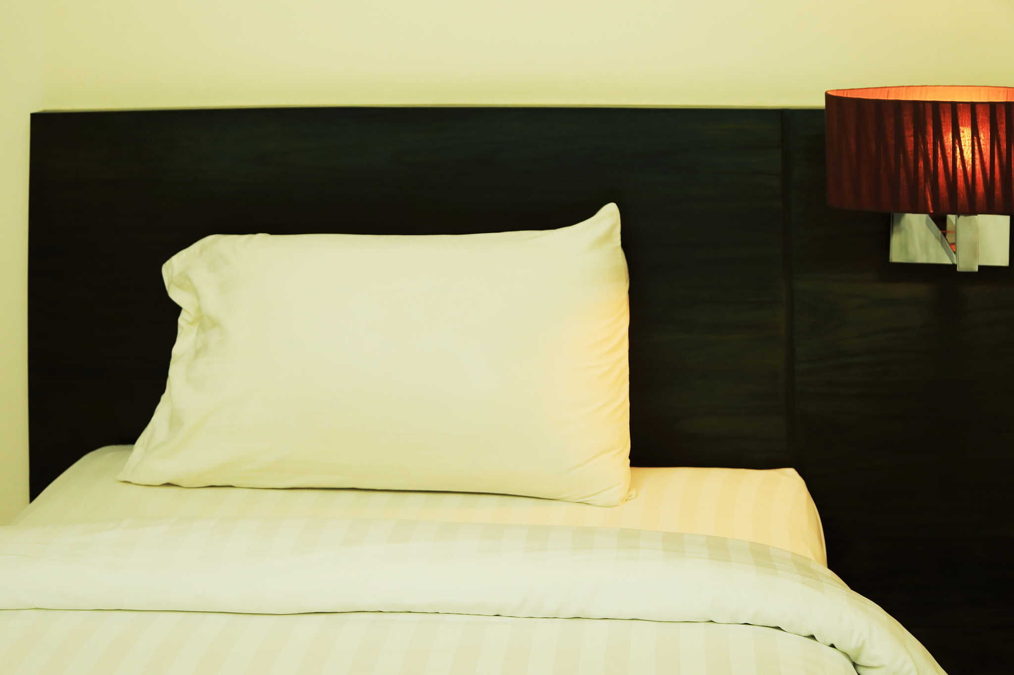 night scene image of comfortable pillows and bed, hotel room int