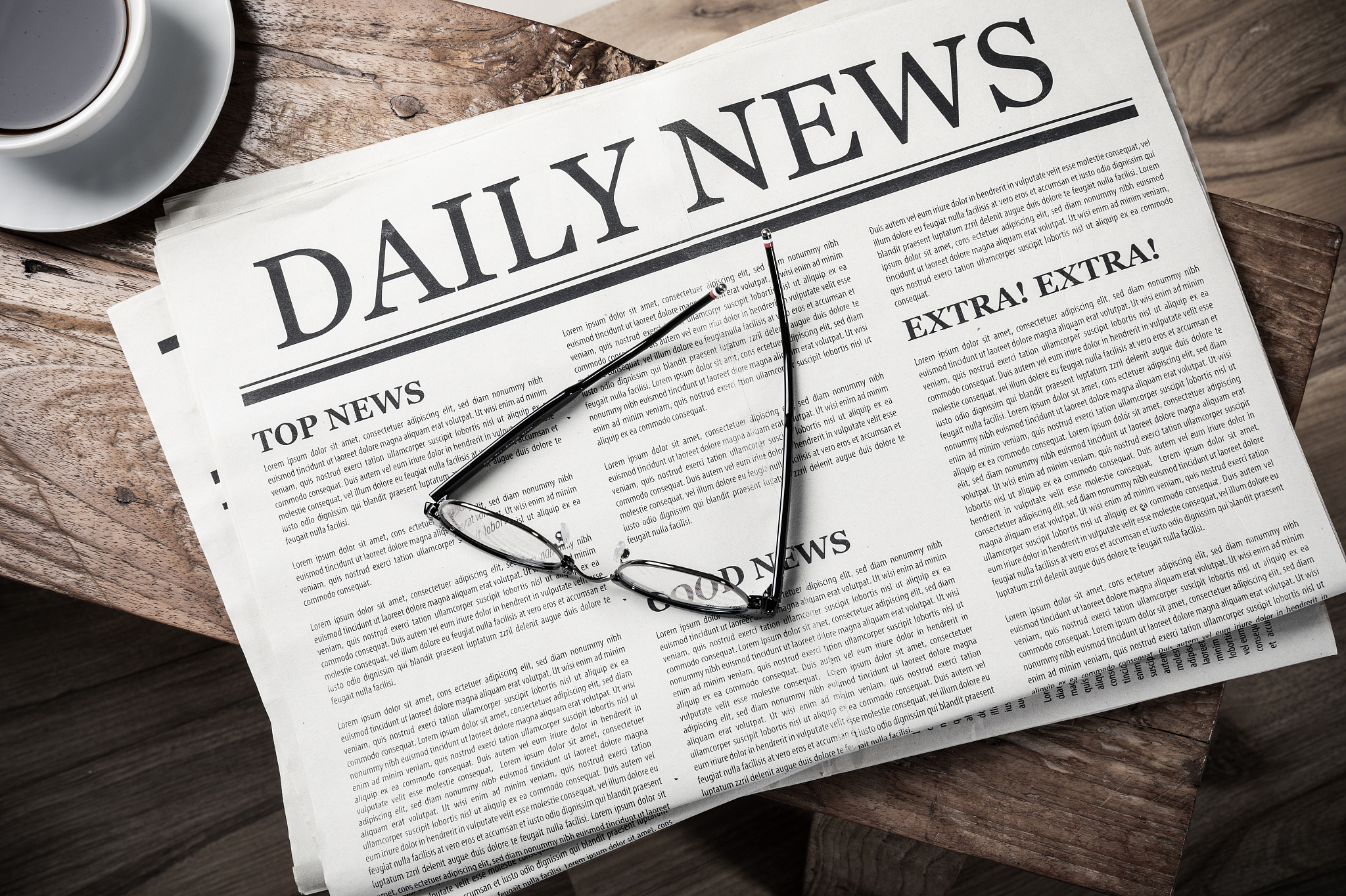 business newspaper on wooden desk with glasses and coffee cup, d