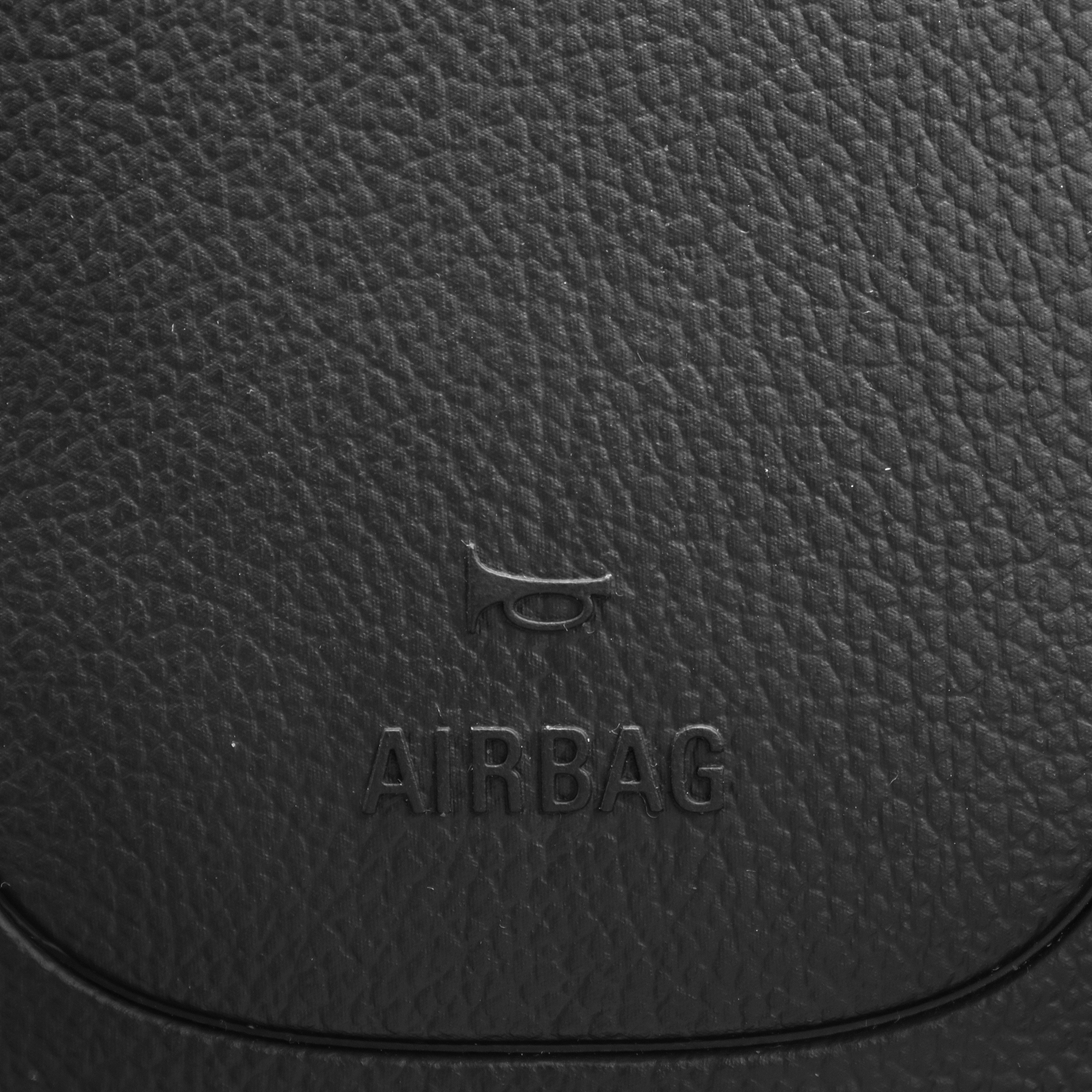 close up of airbag steering wheel symbol