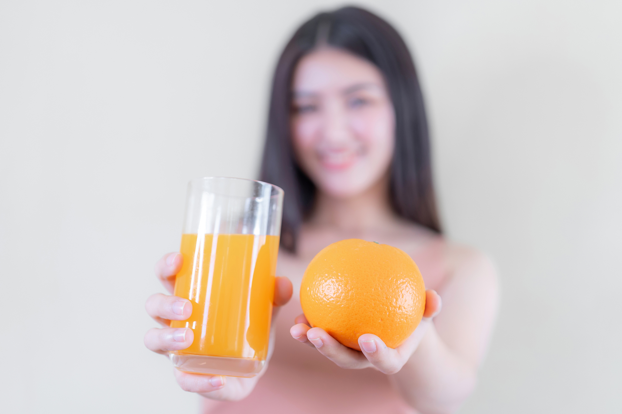beauty woman asian cute girl feel happy holding orange fruit and