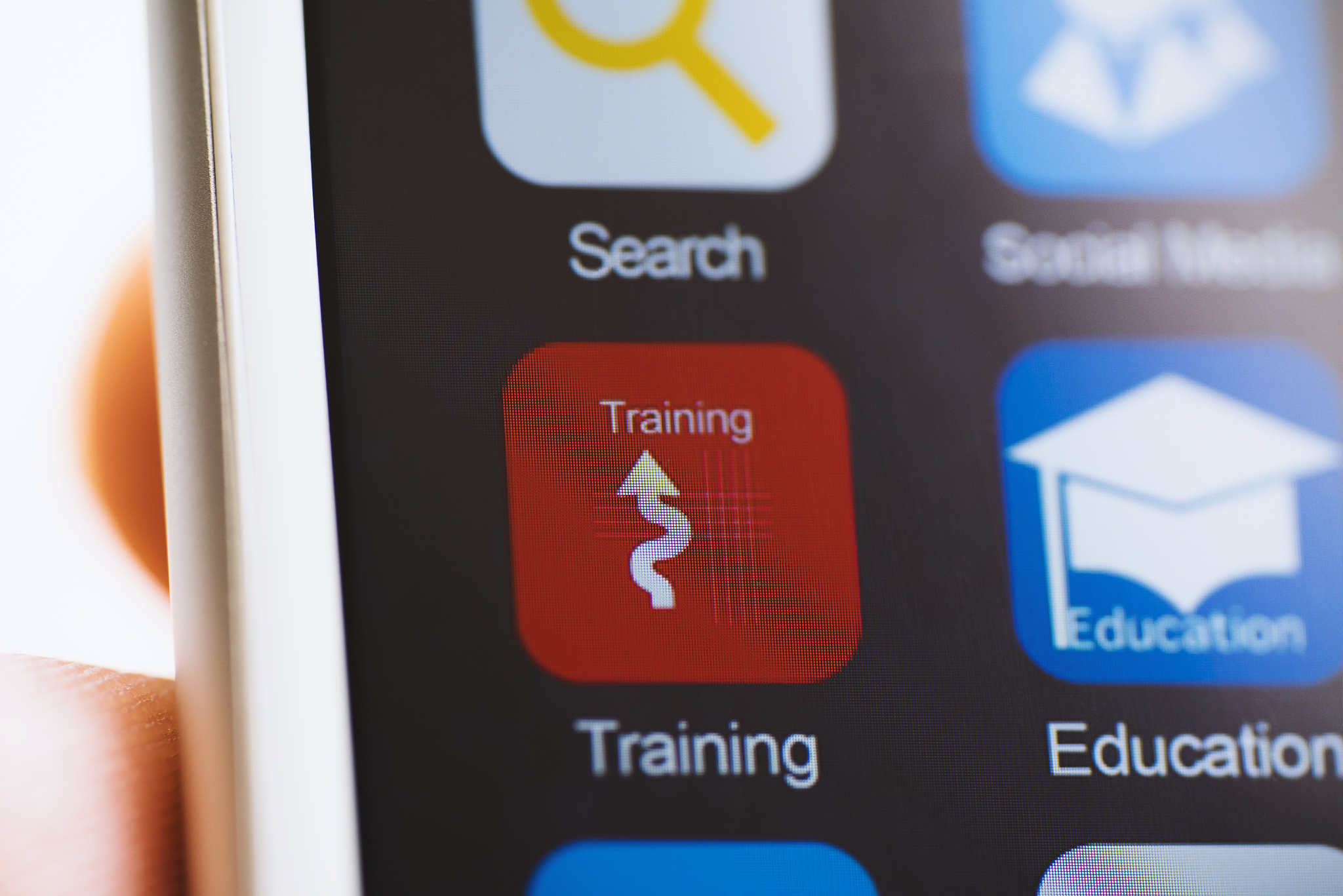 hand holding phone, sport training app icon on screen