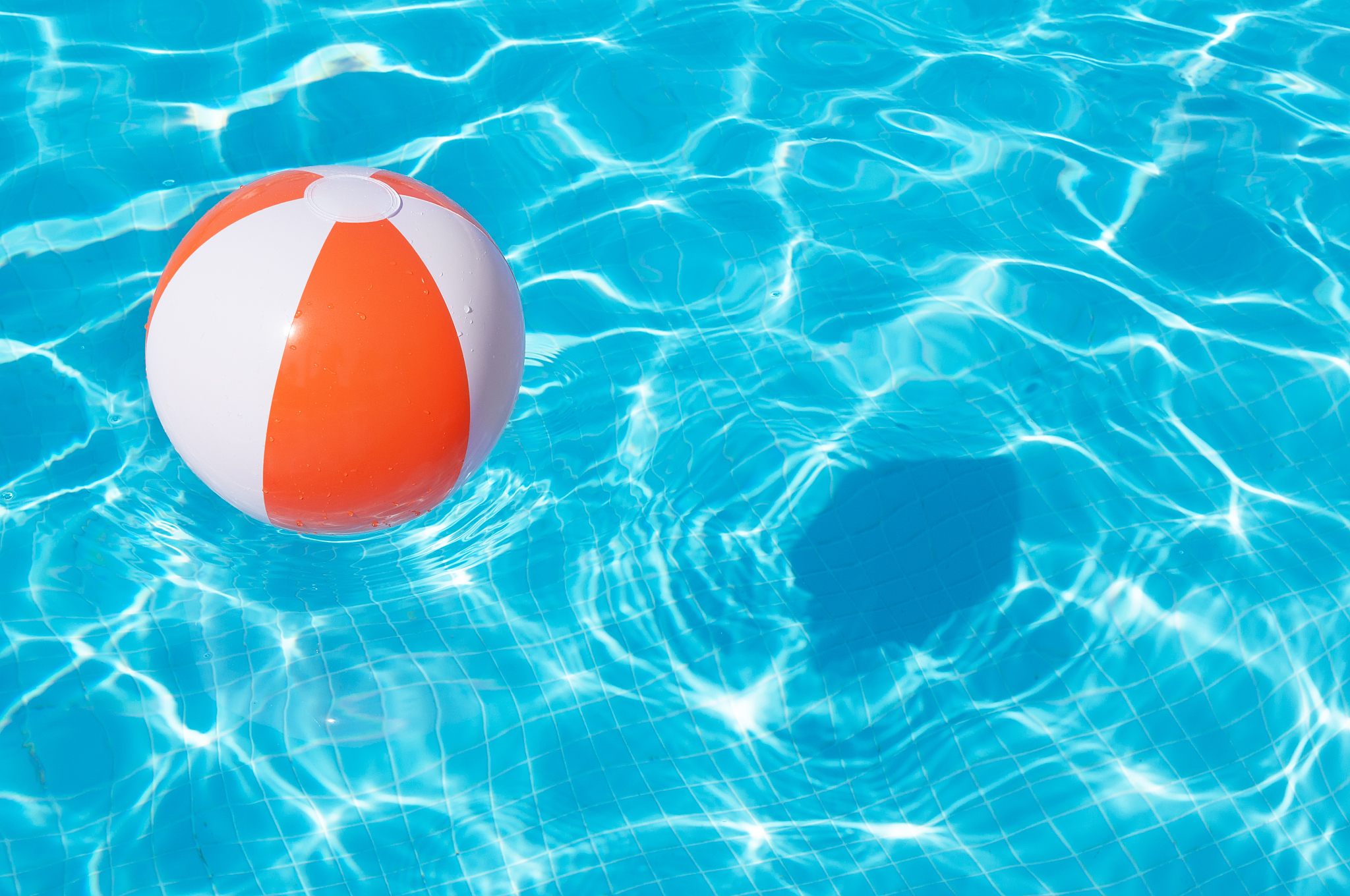 colorful beach ball floating in a pool
