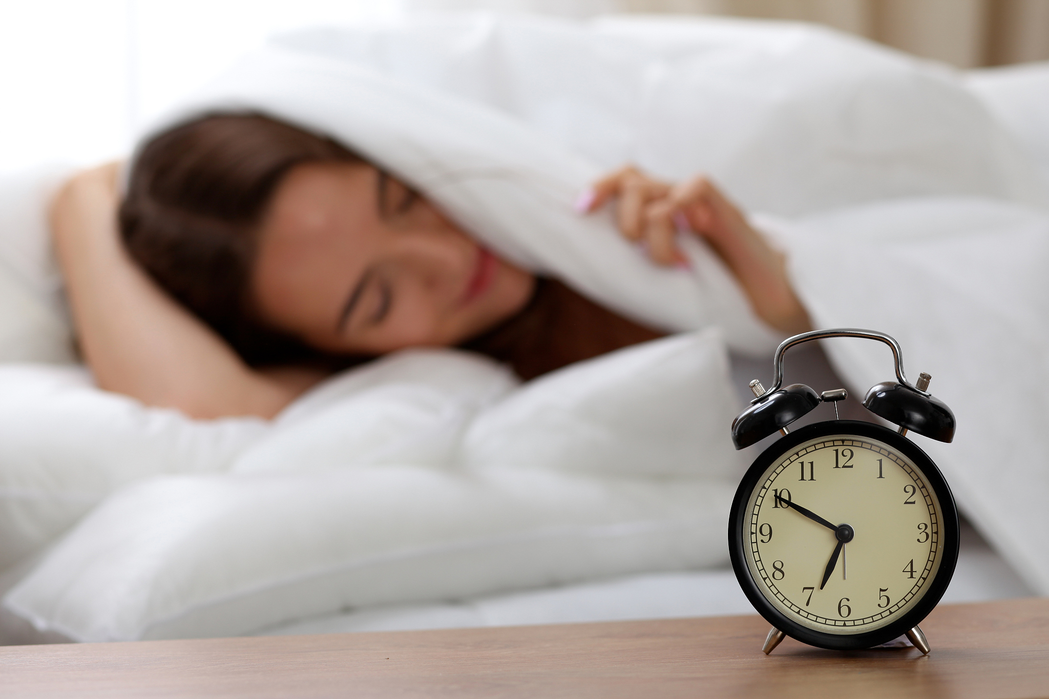 alarm clock standing on bedside table has already rung early mor