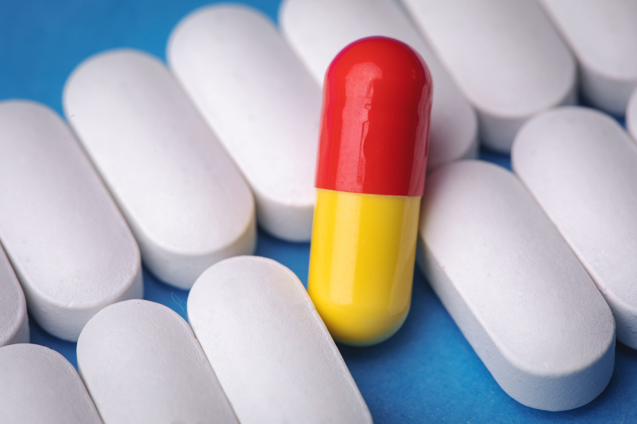 one red pill among white pills. concept of uniqueness