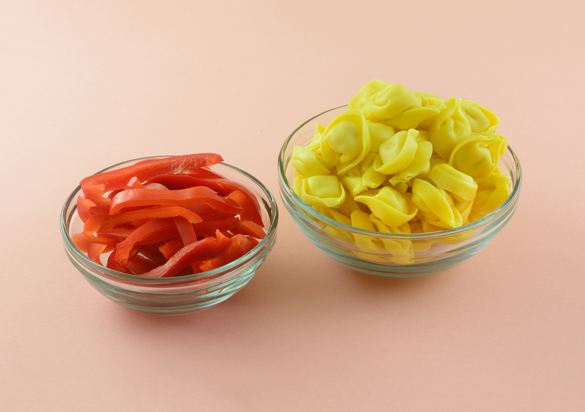 raw tortellini and red bell pepper slices