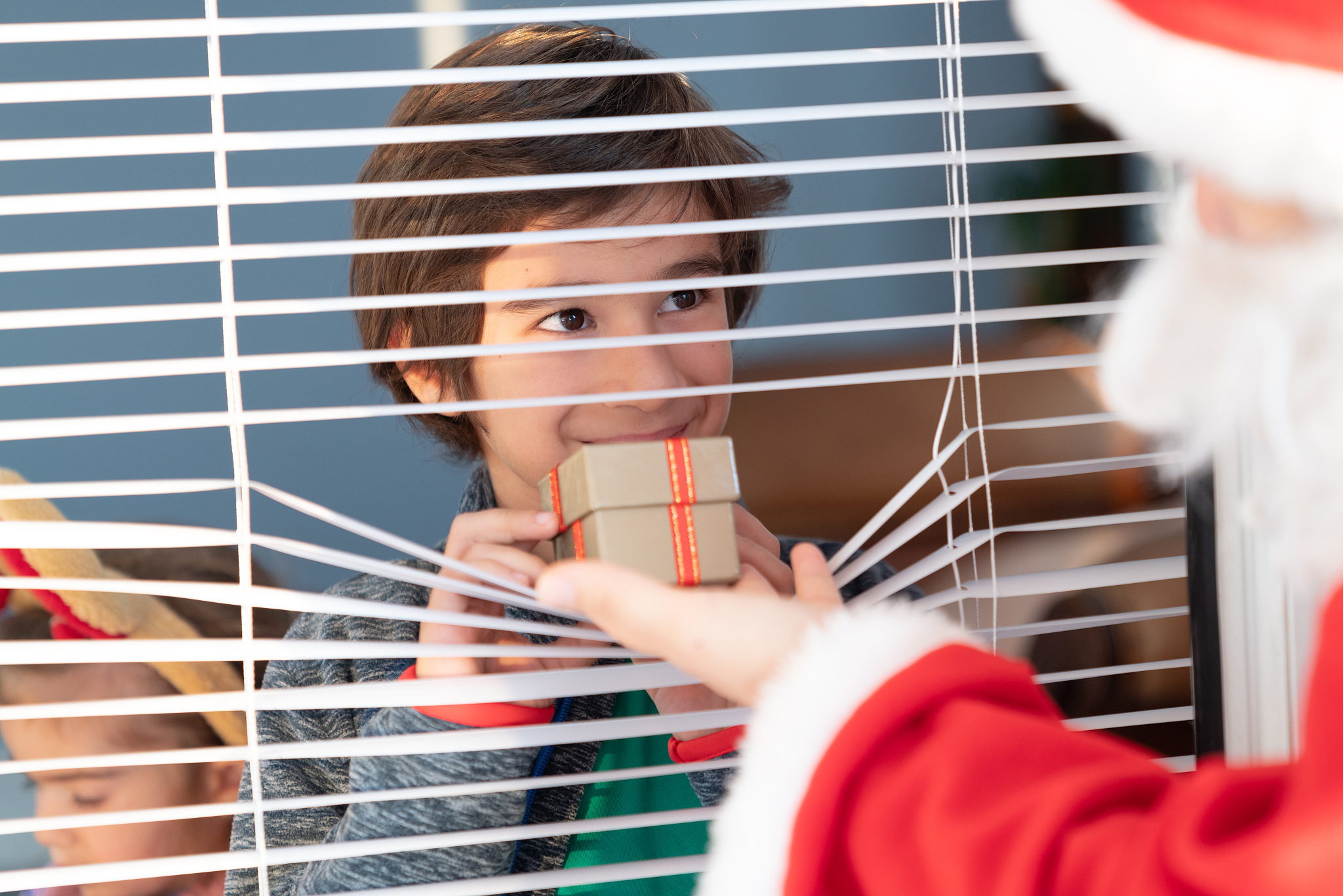 santa claus meeting boy by window