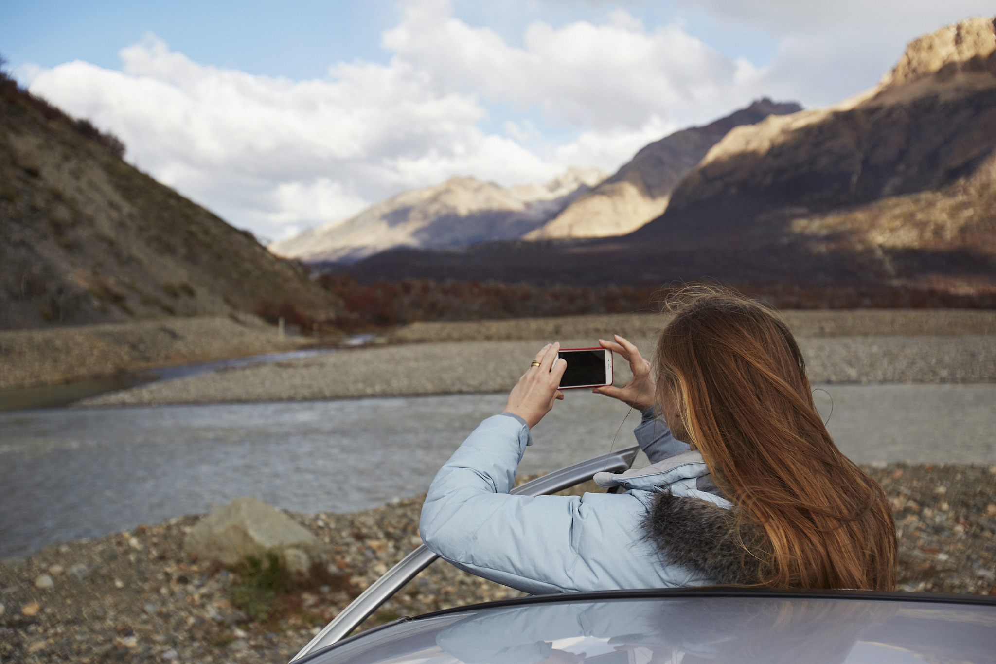 girl takes picture of landscape in patagonia