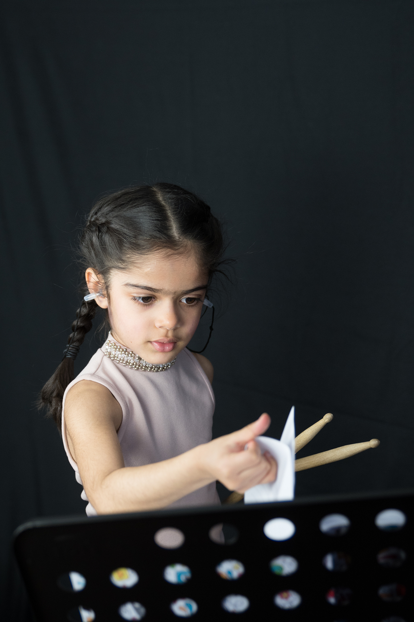 5 year old girl practices the drums