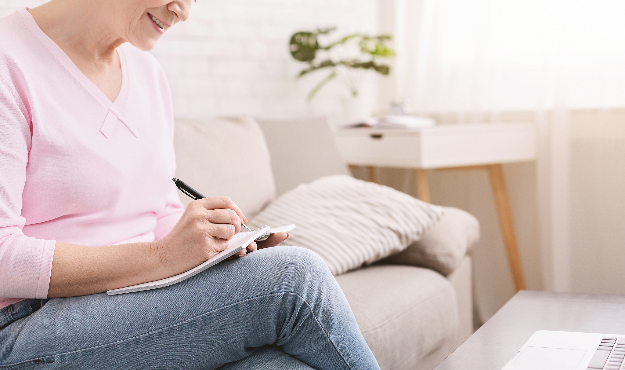retired lady noting thoughts at home, panorama