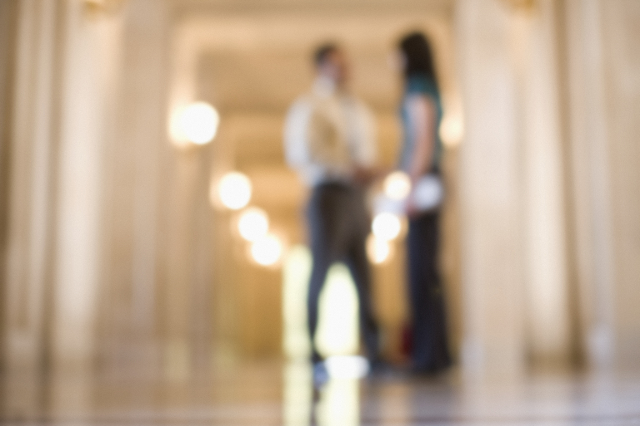 businesspeople talking in a hallway