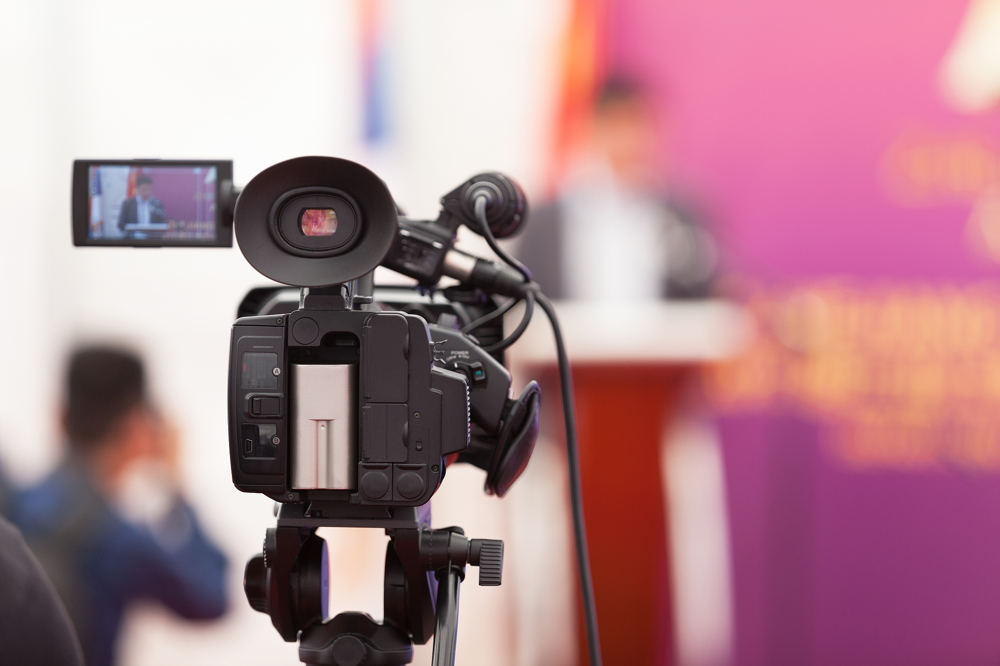 filming an media event with a video camera. press conference.