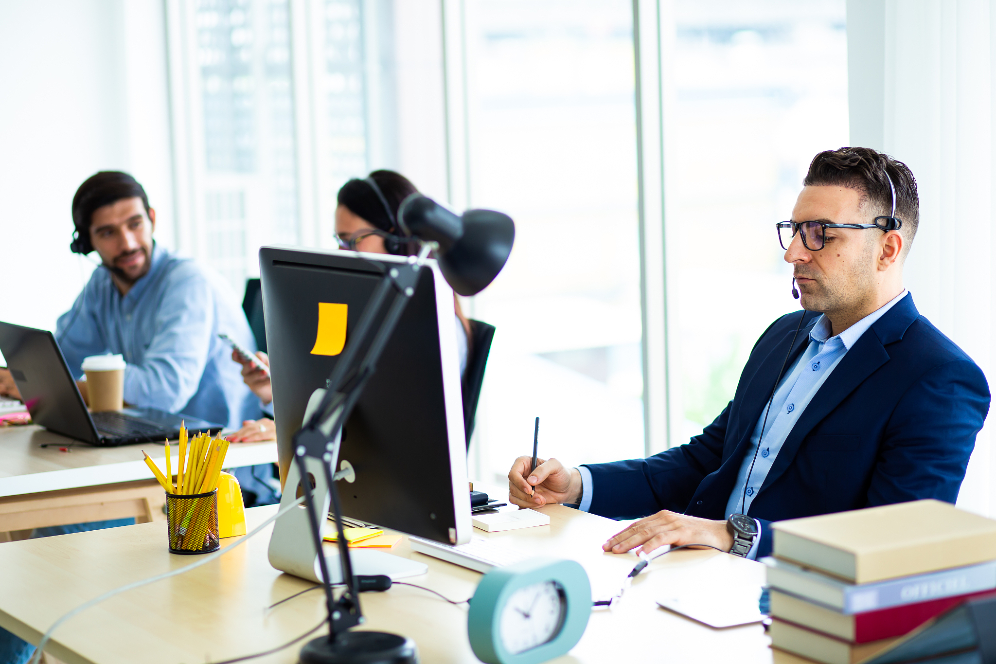 attractive hansome business man in headsets while working with c